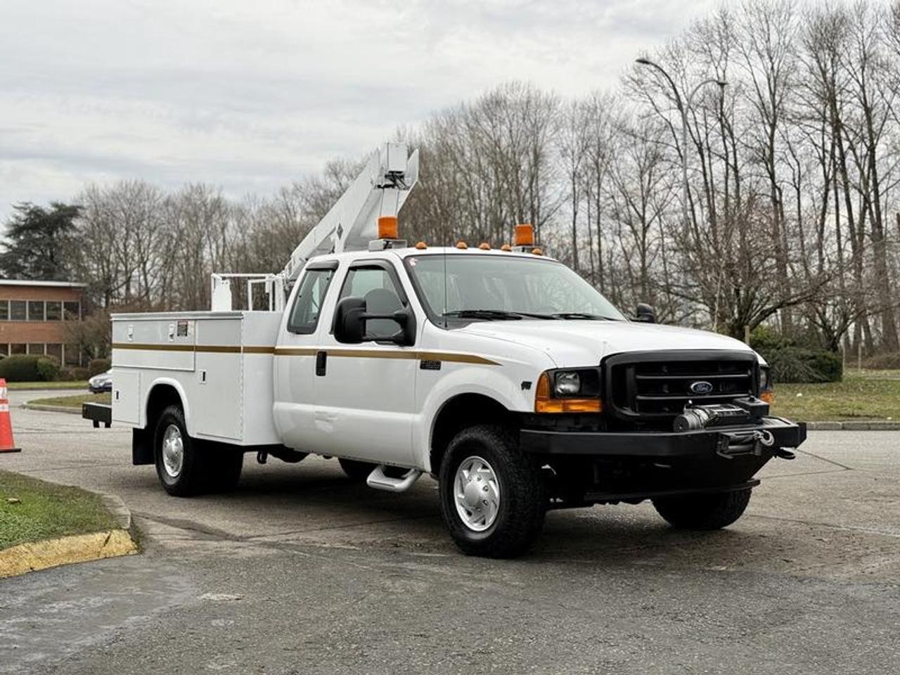This 2001 Ford F-350 XL Super Duty 4x4 Versalift bucket service truck is powered by a 6.8L V10 with an automatic transmission and four-wheel drive, and comes equipped with a Versalift VT-29 BI bucket offering a 29-foot working height. It features auxiliary switches, a battery disconnect, multiple storage compartments, a 12,000 lb winch, and 2-wheel ABS, along with air conditioning and heat, AM/FM radio with cassette player, and cup holders. The truck has a white exterior with a blue cloth interior, four-door cab, and practical service body layout, with overall dimensions of approximately 26 feet long, 7 feet 9 inches wide, and 9 feet high, making it well suited for service, utility, or fleet applications.  $24,710.00 plus $375 processing fee, $25,085.00 total payment obligation before taxes.   Listing report, warranty, contract commitment cancellation fee, financing available on approved credit (some limitations and exceptions may apply). All above specifications and information is considered to be accurate but is not guaranteed and no opinion or advice is given as to whether this item should be purchased. We do not allow test drives due to theft, fraud, acts of vandalism and undetectable impaired driving. Instead we provide the following benefits: Complimentary Warranty (with options to extend), Limited Money Back Satisfaction Guarantee on Fully Completed Contracts, Contract Commitment Cancellation, and an Open-Ended Sell-Back Option. Ask seller for details or call 604-522-REPO(7376) to confirm listing availability.