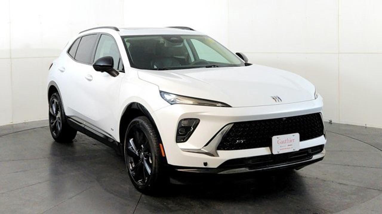 The 2026 Buick Envision Sport Touring delivers athletic styling and premium amenities. Its powered by a 2.0-liter turbocharged 4-cylinder engine paired with a 9-speed automatic transmission and standard all-wheel drive, riding on 20-inch alloy wheels with dark-gloss accents for a more aggressive look. Inside, the cabin features a large 30-inch ultrawide display, heated front seats, a Bose premium sound system, adaptive cruise control, lane-keeping assistance, and a panoramic power moonroof that brings in extra light and openness.