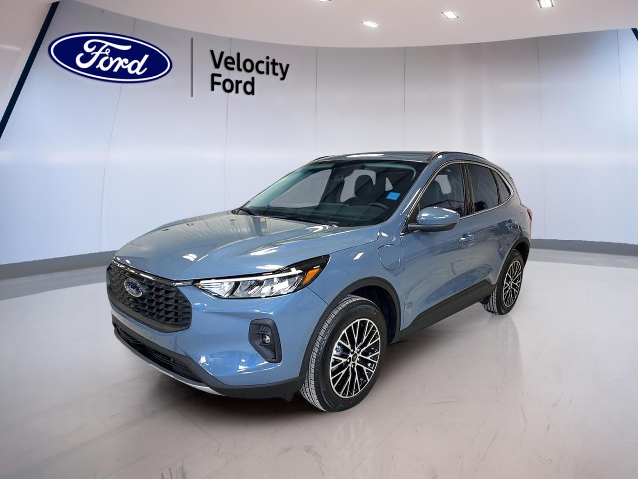 Meet the 2026 Ford Escape Plug-in Hybrid PHEV FWD, now available used at Velocity Ford in Moose Jaw. This Plug-in Hybrid Electric Vehicle (PHEV) is built for drivers who want real flexibility: enjoy electric driving for many local trips, then switch to gas-hybrid power for longer days. Finished in blue with a black interior, its a smart, modern SUV with 4 doors and an easy-to-drive automatic transmission.

Under the hood, the 2026 Ford Escape Plug-in Hybrid PHEV FWD uses a 2.5 L PHEV powertrain designed to help you cut fuel use without giving up everyday comfort. The continuously variable transmission (CVT) keeps power delivery smooth in city traffic and steady on the highway. With its front-wheel-drive layout, this Escape PHEV is a great match for commuting, errands, and weekend plans around Saskatchewan.

PHEV VEHICLE FEATURES  
»» Plug-in hybrid for flexible daily driving  
»» Electric and gas power working together  
»» Charge up, then drive with confidence  
»» Efficient 2.5 L PHEV system  

ADVANCED SAFETY FEATURES  
»» Anti-lock braking system for controlled stops  
»» Stability control helps in slippery conditions  
»» Blind spot monitor for safer lane changes  
»» Lane departure warning for added awareness  

PERFORMANCE AND EFFICIENCY  
»» Automatic transmission with smooth CVT operation  
»» Front-wheel drive for predictable handling  
»» Cruise control for relaxed highway trips  
»» Power steering for easy parking  

COMFORT AND CONVENIENCE  
»» Dual-zone automatic climate control comfort  
»» Heated front seats for cold mornings  
»» Remote starter for pre-warmed cabin  
»» Power windows and automatic door locks  

TECHNONOLGY AND CONNECTIVITY  
»» Navigation system with clear route guidance  
»» Bluetooth integration for hands-free calling  
»» WiFi hotspot for connected passengers  
»» Steering wheel audio controls included  

CARGO SPACE  
»» Power liftgate for easy loading  
»» Rear trunk access for daily practicality  
»» Rear spoiler adds functional finishing touch  
»» Spare tire included for peace of mind  

WHAT OTHER OWNERS LIKE  
»» Plug-in hybrid efficiency for daily commuting  
»» Confident visibility with backup camera  
»» Easy winter use with heated mirrors  
»» Simple driving with push-button start  

This Escape also includes LED headlamps, fog lights, automatic headlights, tinted windows, heated mirrors, electric mirrors, tire pressure monitoring, child safety locks, multiple airbags including side impact and head side airbags, plus a drivers seat power adjustment with lumbar support. Satellite radio is onboard for more listening choice, and the backup camera helps make tight parking in town far less stressful.

If you want a PHEV SUV that fits real life in Moose Jaw, the 2026 Ford Escape Plug-in Hybrid PHEV FWD delivers comfort, useful tech, and the everyday advantage of plug-in efficiency in one well-rounded package.

This 2026 Ford Escape Plug-in Hybrid PHEV FWDs VIN is: 1FMCU0E1XTUA25743.