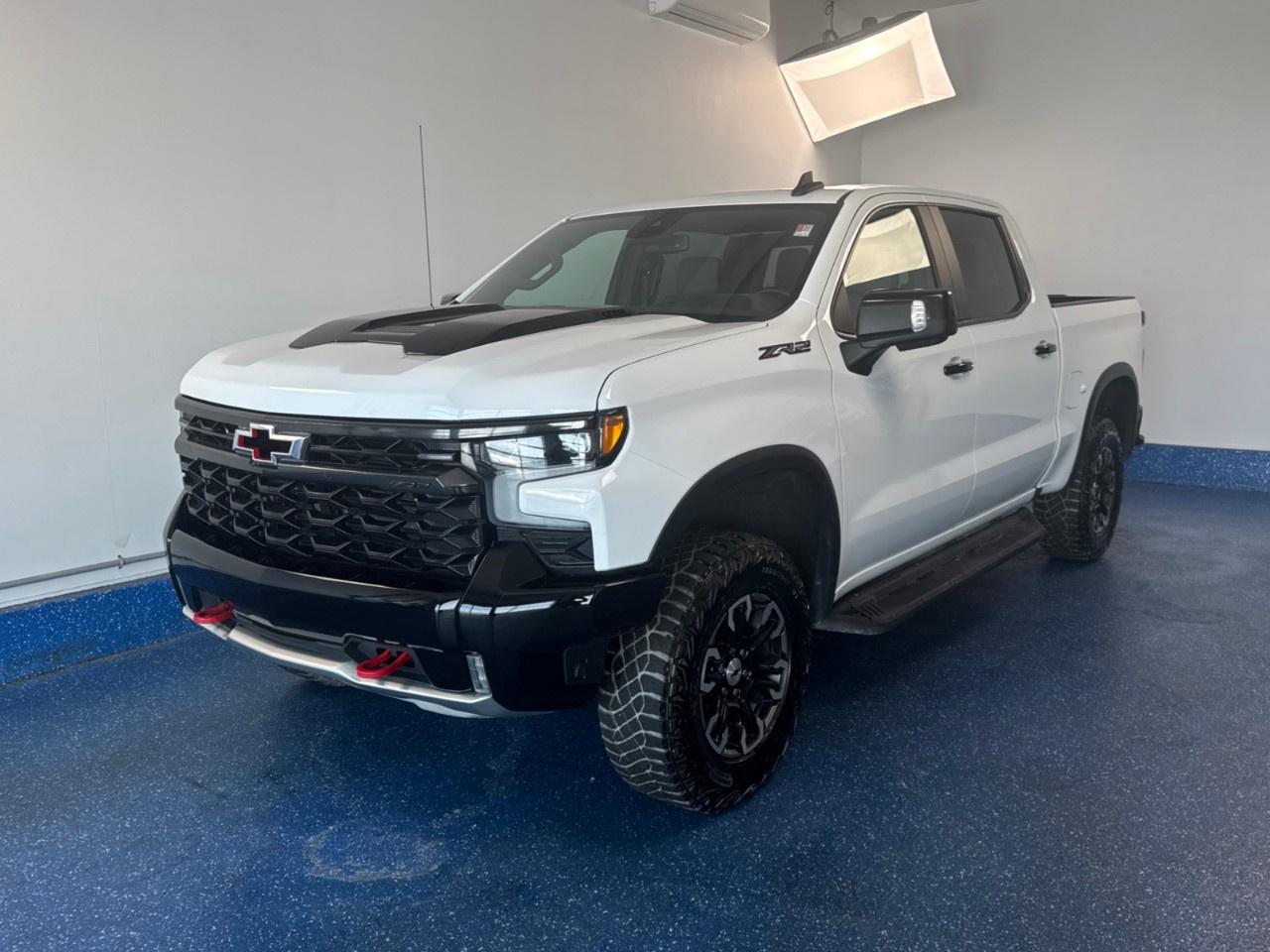 New Price! 2024 Chevrolet Silverado 1500 ZR2 Crew Cab ZR2 | 6.2L V8 | One Owner | Low Kms | Zac Certified. 10-Speed Automatic 4WD Summit White EcoTec3 6.2L V8<br /><br /><br />10-Speed Automatic, 4WD, Jet Black w/Perforated Leather-Appointed Front Seat Trim, 10-Way Power Driver Seat w/Lumbar, 10-Way Power Passenger Seat Adjuster w/Lumbar, 12.3''' Multicolour Reconfigurable Digital Display, 120-Volt Bed Mounted Power Outlet, 120-Volt Interior Power Outlet, 2 USB Data Ports, 2nd Row Heated Outboard Seats, 3 Years of OnStar & Connected Services Plan, 6''' Rectangular Black Tubular Assist Steps (LPO), Air Conditioning, All-Weather Floor Liner (LPO), AM/FM radio: SiriusXM with 360L, Apple CarPlay/Android Auto, Auto-Dimming Inside Rear-View Mirror, Automatic temperature control, Bed View Camera, Black Name Plates (LPO), Black Tailgate CHEVROLET Lettering (LPO), Bluetooth® For Phone, Chevrolet Connected Access Capable, Chevytec Spray-On Black Bedliner, Colour-Keyed Carpeting Floor Covering, Dark Essentials Package (LPO), Deep-Tinted Glass, Driver Memory, Dual Rear USB Ports (Charge Only), Electric Rear-Window Defogger, Electrical Steering Column Lock, Electronic Cruise Control, EZ Lift Power Lock & Release Tailgate, Floor Mounted Centre Console, Forward Collision Alert, Front fog lights, Front LED Fog Lamps, Front Pedestrian Braking, Front Rainsensing Wipers, Front reading lights, HD Surround Vision, Heated door mirrors, Heated Driver & Front Outboard Passenger Seats, Heated front seats, Heated rear seats, Heated Steering Wheel, Heated steering wheel, Heavy-Duty Air Filter, High Gloss Black Mirror Caps, Hill Descent Control, Hitch Guidance, Hitch Guidance w/Hitch View, In-Vehicle Trailering System App, Integrated Trailer Brake Controller, IntelliBeam Automatic High Beam On/Off, Keyless Open & Start, Lane Keep Assist w/Lane Departure Warning, LED Cargo Area Lighting, Manual Tilt/Telescoping Steering Column, Memory seat, Off-Road Assist Steps (LPO), OnStar & Chevrolet Connected Services Capable, Outside Heated Power-Adjustable Mirrors, Perforated Leather Seat Trim, Performance Red Recovery Hooks, Perimeter Lighting, Power driver seat, Power Front Passenger Windows w/Express Up/Down, Power Front Windows w/Driver Express Up/Down, Power Rear Windows w/Express Down, Power Sliding Rear Window w/Rear Defogger, Power steering, Power Sunroof, Power windows, Preferred Equipment Group 3LT, Premium audio system: Chevrolet Infotainment 3 Premium, Premium Bose 7-Speaker Sound System, Radio: Chevrolet Infotainment 3 Premium System, Rain sensing wipers, Rear Cross Traffic Braking, Rear Park Assist, Rear Pedestrian Alert, Rear step bumper, Rear Wheelhouse Liners, Remote keyless entry, Remote Vehicle Starter System, Safety Alert Seat, SiriusXM w/360L, Standard Tailgate, Steering Wheel Audio Controls, Telescoping steering wheel, Theft Deterrent System (Unauthorized Entry), Tilt steering wheel, Trailer Camera Provisions, Trailer Side Blind Zone Alert, Trailering Package, Universal Home Remote, Up-Level Rear Seat w/Storage Package, Ventilated Driver & Front Passenger Seats, Wheels: 18''' x 8.5''' Aluminum Machined Face, Wi-Fi Hot Spot Capable, Wrapped Steering Wheel, ZR2 Suspension Package.<br /><br />Certification Program Details: Fresh 2 Yr MVI | 30 day warranty* | 110 point inspection | Full tank of fuel | Krown rustproofed | Flexible financing options | Professionally detailed<br /><br />This vehicle is Zacks Certified! You're approved! We work with you. Together we'll find a solution that makes sense for your individual situation. Please visit us or call 902 843-3900 to learn about our great selection.<br /><br />With 22 lenders available Zack's Auto Sales can offer our customers with the lowest available interest rate. Thank you for taking the time to check out our selection!