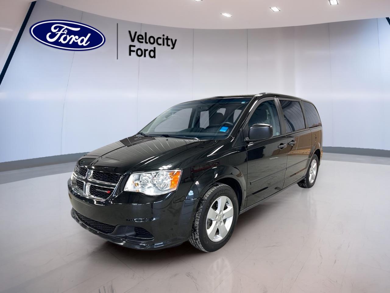Meet a family favourite that keeps life simple. This used 2016 Dodge Grand Caravan 4dr Wgn Canada Value Package at Velocity Ford in Moose Jaw offers practical space, proven V6 power, and easy everyday comfort. Finished in Black with a Grey interior, it is built for busy schedules, road trips, and daily errands alike.

With 91,717 km, this Grand Caravan 4dr Wgn Canada Value Package presents a smart choice for drivers who want value and versatility. Its 3.6-litre unleaded engine and 6-speed automatic transmission deliver smooth response, while front-wheel drive helps provide confident handling in changing Canadian conditions.

FEATURES OF THE Grand Caravan 4dr Wgn Canada Value Package
»» 3.6-litre V6 with automatic transmission
»» Front-wheel drive for everyday confidence
»» Dual-zone climate control for comfort
»» Power windows and heated mirrors

ADVANCED SAFETY FEATURES
»» Anti-lock braking system for controlled stops
»» Stability control helps maintain vehicle balance
»» Driver and passenger front airbags
»» Side and head airbags included

PERFORMANCE AND EFFICIENCY
»» 3.6-litre unleaded V6 delivers smooth power
»» Six-speed automatic supports relaxed highway cruising
»» Front-wheel drive for all-season usability
»» Power steering adds easy low-speed manoeuvres

COMFORT AND CONVENIENCE
»» Front air conditioning keeps cabin comfortable
»» Dual-zone climate control adds flexibility
»» Cruise control supports easier long drives
»» Adjustable steering wheel improves driving position

TECHNONOLGY AND CONNECTIVITY
»» Steering wheel audio controls add convenience
»» Clear driver controls are easy to use
»» Automatic door locks add daily ease
»» Power windows simplify passenger access

CARGO SPACE
»» Minivan layout supports flexible cargo needs
»» Four-door design improves family access
»» Rear area suits groceries and gear
»» Spacious cabin helps manage busy days

AWARDS & RECOGNITIONS
»» Lowest Cost to Own Minivan, Kelley Blue Book, 2016

WHAT OTHER OWNERS LIKE
»» Strong V6 power for daily driving
»» Useful cabin space for family needs
»» Easy entry and practical controls
»» Comfortable ride for longer trips

This used Dodge minivan focuses on the basics that matter most. Heated and electric mirrors help in cold weather, while the rear window defroster supports clear visibility when temperatures drop. Steel wheels add durability, and the rear spoiler gives the exterior a clean, sporty touch.

Inside, the layout is straightforward and functional. Illuminated driver and passenger vanity mirrors add a helpful touch, and the passenger airbag sensor supports everyday peace of mind. Child safety locks make this van a sensible fit for family duty, while tire pressure monitoring helps you stay aware on the road.

For drivers in Moose Jaw who want room, comfort, and trusted Dodge capability, this 2016 Dodge Grand Caravan 4dr Wgn Canada Value Package is ready to deliver dependable value. It is a practical minivan designed to handle the real needs of Canadian drivers without overcomplicating the experience.

This 2016 Dodge Grand Caravan 4dr Wgn Canada Value Packages VIN is: 2C4RDGBG7GR331690.