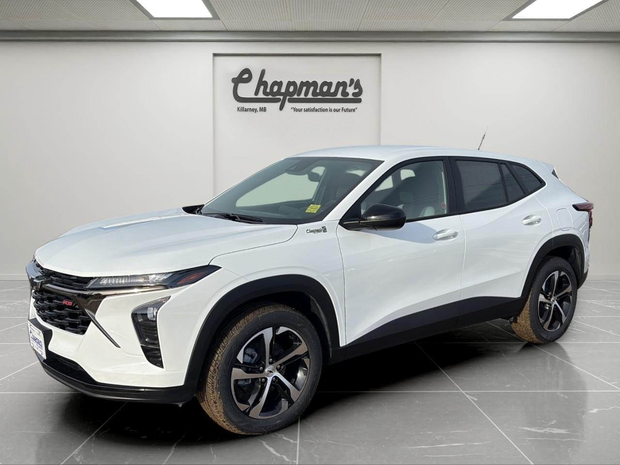 <p>The 2026 Chevrolet Trax 1RS FWD delivers bold sport styling, impressive fuel efficiency, and modern connectivity in a compact SUV built for urban life. Finished in <strong>Summit White</strong> with a <strong>Jet Black interior</strong>, this 1RS trim stands out with blacked-out accents and 18-inch black wheels for a confident, athletic look.</p><p>Powered by the <strong>ECOTEC 1.2L Turbocharged engine</strong> paired with a <strong>6-speed automatic transmission</strong>, the Trax offers responsive performance and excellent efficiency for daily commuting.</p><h3><strong>Performance & Efficiency</strong></h3><p>Smart turbocharged power built for city and highway driving.</p><ul><li><p>ECOTEC 1.2L Turbo Engine</p></li><li><p>6-Speed Automatic Transmission</p></li><li><p>Front-Wheel Drive</p></li><li><p>StabiliTrak Stability Control with Traction Control</p></li><li><p>Electric Power Steering</p></li><li><p>Engine Block Heater</p></li></ul><p>Fuel efficiency is rated at <strong>8.1 L/100 km combined</strong> (8.5 city / 7.6 highway).</p><h3><strong>Interior Comfort & Convenience</strong></h3><p>Sporty touches meet practical everyday features.</p><ul><li><p>Heated Driver & Front Passenger Seats</p></li><li><p>Heated Steering Wheel</p></li><li><p>6-Way Manual Driver Seat</p></li><li><p>4-Way Manual Passenger Seat</p></li><li><p>60/40 Split-Folding Rear Seat</p></li><li><p>Remote Vehicle Start</p></li><li><p>Deep-Tinted Rear Glass</p></li><li><p>Rear Window Defogger</p></li><li><p>Front Armrest with Storage</p></li></ul><h3><strong>Technology & Connectivity</strong></h3><p>Modern infotainment keeps you seamlessly connected.</p><ul><li><p>Chevrolet Infotainment 3 System</p></li><li><p>8" Diagonal Colour Touchscreen</p></li><li><p>Wireless Apple CarPlay</p></li><li><p>Wireless Android Auto</p></li><li><p>Bluetooth Audio Streaming (2 Active Devices)</p></li><li><p>Steering Wheel Audio & Phone Controls</p></li><li><p>SiriusXM with Trial Subscription</p></li><li><p>OnStar Basics (Up to 8 Years)</p></li><li><p>4-Speaker Audio System</p></li><li><p>Active Noise Cancellation</p></li></ul><h3><strong>Safety & Driver Assistance</strong></h3><p>Standard Chevrolet Safety Assist technologies provide added peace of mind.</p><ul><li><p>Forward Collision Alert</p></li><li><p>Automatic Emergency Braking</p></li><li><p>Front Pedestrian Braking</p></li><li><p>Lane Keep Assist with Lane Departure Warning</p></li><li><p>Following Distance Indicator</p></li><li><p>IntelliBeam Automatic High Beams</p></li><li><p>Rear Vision Camera</p></li><li><p>Rear Park Assist</p></li><li><p>Rear Cross Traffic Alert</p></li><li><p>Lane Change Alert with Side Blind Zone Alert</p></li><li><p>Tire Pressure Monitoring System</p></li></ul><h3><strong>Exterior Highlights</strong></h3><p>Athletic RS styling with modern lighting and bold accents.</p><ul><li><p>18" Black Painted Machined Aluminum Wheels</p></li><li><p>LED Headlamps</p></li><li><p>Daytime Running Lamps</p></li><li><p>High Gloss Black Mirror Caps</p></li><li><p>Rear Spoiler</p></li><li><p>Body-Colour Door Handles</p></li><li><p>Heated Power Adjustable Outside Mirrors</p></li></ul><p>With sporty RS design, advanced safety features, modern connectivity, and impressive fuel economy, the 2026 Chevrolet Trax 1RS FWD delivers strong value in a stylish and practical compact SUV.</p><p>2 Year/24,000 kilometer* Complimentary Oil Changes (2 total)</p><p>3 Year/60,000 kilometer* Base Warranty Coverage</p><p>5 Year/100,000 kilometer* Powertrain Component Warranty Coverage</p><p>5 Year/100,000 kilometer* Courtesy Transportation and 24/7 Roadside Assistance</p><p>6 Year/160,000 kilometer* Sheet Metal (Rust Through) Perforation Warranty Coverage</p><p>*Whichever Comes First.</p><p>Price Includes Dealer Fee.</p><p>Price Excludes PST & GST.</p><p>Financing Options Available, Call For More Details.</p> <p><strong>*While every reasonable effort is made to ensure the accuracy of this information, we are not responsible for any error or omissions contained on these pages. Please verify any information in question with Chapman Motors Ltd.</strong></p>