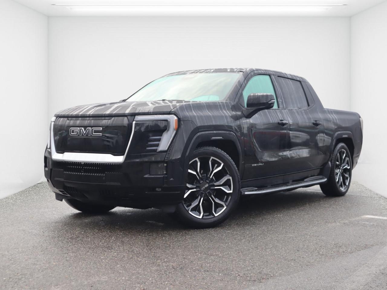 Apple Carplay | Head Up Display | 740 km range | Powered Front Trunk | Navigation | 360 Degree View Camera | Blind Spot Monitoring | Remote Keyless Entry | Push Button Start | Panoramic Sunroof | Wireless phone Charging | Heated Steering Wheel | Ventilated Seats | Adaptive Cruise Control | <br><br>2025 GMC Sierra EV Denali<br><br>Now available at Murray Hyundai White Rock, this 2025 GMC Sierra EV Denali redefines what a full-size pickup can be with bold electric performance and Denali-level luxury. Featuring a dual-motor AWD electric powertrain, it delivers instant torque, confident all-weather capability, and impressive driving rangeperfect for BC roads.<br><br>This top-of-the-line Denali trim offers premium features including Super Cruise hands-free driving (where equipped), adaptive air suspension, four-wheel steering, and the innovative MultiPro Midgate for added cargo versatility. Inside, enjoy a refined cabin with premium materials, advanced digital displays, and cutting-edge technology throughout.<br><br>Powerful, quiet, and exceptionally capable, the Sierra EV Denali is the future of trucksavailable today.<br><br> Visit Murray Hyundai White Rock to experience electric luxury and capability firsthand.<br><br><br>Recent Arrival! 2025 GMC Sierra EV Denali Black Electric 1-Speed Automatic AWD<br><br><br>Why Buy From us? <br>*7x Hyundai Presidents Award of Merit Winner <br>*3x Consumer Choice Award for Business Excellence <br>*AutoTrader Dealer of the Year <br><br>M-Promise Certified Preowned ($995 value): <br>- 30-day/2,000 Km Exchange Program <br>- 3-day/300 Km Money Back Guarantee <br>- Comprehensive 144 Point Mechanical Inspection <br>- Full Synthetic Oil Change <br>- BC Verified CarFax <br>- Minimum 6 Month Power Train Warranty<br><br>Our vehicles are priced under market value to give our customers a hassle free experience. We factor in mechanical condition, kilometres, physical condition, and how quickly a particular car is selling in our market place to make sure our customers get a great deal up front and an outstanding car buying experience overall. At White Rock Hyundai, we help you get where you want to go. *All vehicle purchases are subject to a $799 administration fee. *Dealer #31129.<br><br><br>CALL NOW!! This vehicle will not make it to the weekend!!