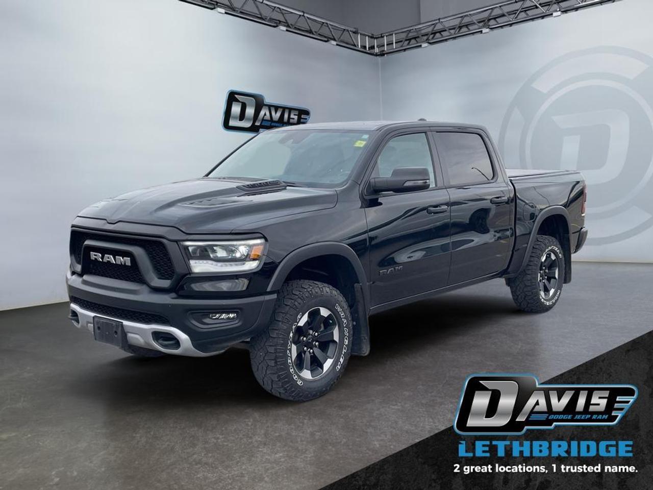 <b>Off-Road Suspension, SiriusXM, Apple CarPlay, Android Auto, Navigation!<br /> <br /></b><br /> The 2023 Ram 1500 Rebel is a rugged, off-road-ready pickup designed for drivers who demand power and style. Equipped with a 5.7L V8 HEMI engine and 8-speed automatic transmission, this 4x4 Rebel delivers strong towing capability, impressive off-road performance, and a confident ride with raised suspension, electronic locking rear axle, and Selec-Speed control. Its aggressive exterior features black Rebel badging, powder-coated front bumper, off-road wheel flares, and 18-inch black alloy wheels.<br /><br />Inside, the cabin blends comfort and utility with cloth and vinyl bucket seats, heated front seats, a heated steering wheel, and a full-length upgraded floor console. Technology is highlighted by the 12-inch Uconnect 5 touchscreen with navigation, Apple CarPlay, Android Auto, Bluetooth, and a premium 9-speaker audio system. Safety and convenience features include ParkView rear backup camera, blind spot monitoring, trailer sway damping, and advanced multistage front airbags.<br /><br />Built for adventure and everyday tasks, the 2023 Ram 1500 Rebel combines rugged capability, modern tech, and bold styling in a pickup that stands out both on and off the road.<br /> <br />To apply right now for financing use this link: <a href=https://lethbridge.davisdodge.ca/free-credit-check/ target=_blank rel=nofollow noopener noreferrer>https://lethbridge.davisdodge.ca/free-credit-check/</a><br /><br /> <br /><br />Locally Owned & Trusted for Over 35 Years  Davis Dodge in Lethbridge, AB <br /><br /> At Davis Dodge, weve proudly served the Lethbridge community for more than 35 years, offering an unparalleled car buying experience. Dont just take our word for itour Google reviews speak volumes about our commitment to exceptional service. <br /><br /> Delivery & At-Home Test Drives: Convenient options to suit your lifestyle. <br /><br /> Flexible Financing for Everyone: Get the vehicle you need with financing solutions tailored to your situation. <br /><br /> Full Mechanical Inspections & Professional Cleaning: Every vehicle is thoroughly inspected and cleaned before it hits our lot.<br /><br /> We take all makes and models on trade and offer competitive pricing with inventory that changes daily. Whether you're shopping for a Chrysler, Dodge, Jeep, RAM, or FIAT, our AMVIC Licensed dealership makes it easy to browse, buy, and drive away.<br /><br /> Located in Lethbridge, AB, we proudly serve customers in Fort Macleod, Taber, Claresholm, and Coaldale. Shop online or visit us today to experience the best in sales, service, and selection. Standard bank rates apply; taxes are additional.<br /><br /> Vehicle pricing offer shown expires 2026-04-30. <br /> Come by and check out our fleet of 80+ used cars and trucks and 110+ new cars and trucks for sale in Lethbridge. o~o