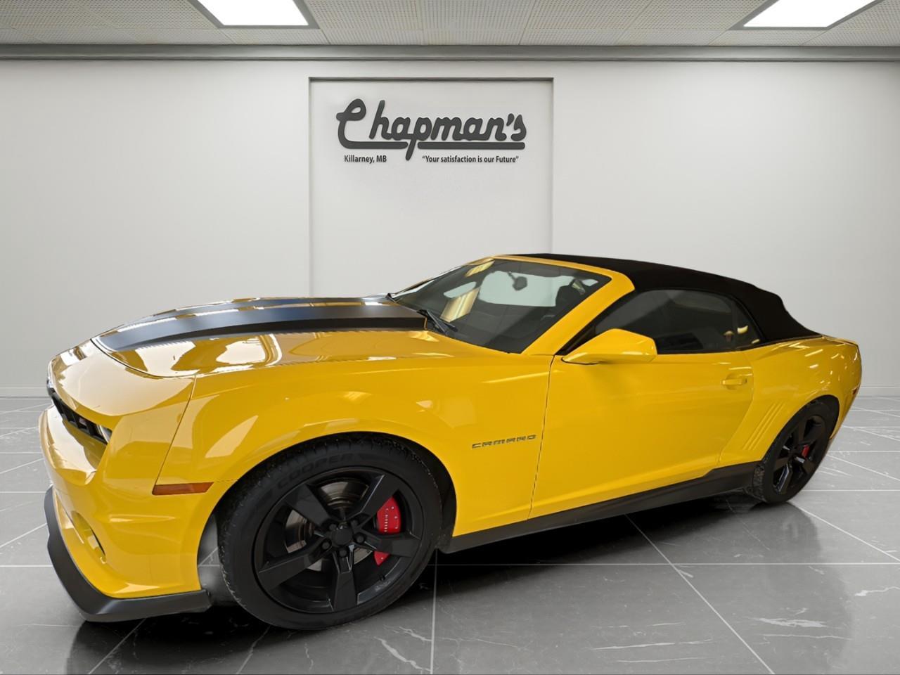 <p>The 2011 Chevrolet Camaro 1SS Convertible delivers classic muscle car performance with open-air driving excitement. Finished in <strong>Rally Yellow</strong> with a <strong>Black interior</strong> and <strong>black convertible top</strong>, this Camaro stands out with aggressive SS styling, a powerful V8 engine, and a driver-focused 6-speed manual transmission.</p><p><strong>Performance & Capability</strong></p><p>Iconic V8 power paired with a performance-tuned drivetrain for an engaging drive.</p><ul><li><p>6.2L V8 Engine</p></li><li><p>6-Speed Manual Transmission</p></li><li><p>Performance Suspension</p></li><li><p>Limited Slip Rear Differential</p></li><li><p>Power Steering</p></li><li><p>Hurst Shifter</p></li><li><p>Federal Emissions System</p></li></ul><p><strong>Interior Comfort & Convenience</strong></p><p>A sport-focused cabin designed for control, comfort, and driving enjoyment.</p><ul><li><p>Front Cloth Sport Bucket Seats</p></li><li><p>Leather-Wrapped Steering Wheel</p></li><li><p>Air Conditioning</p></li><li><p>Gauge Cluster with Tachometer</p></li><li><p>Steering Wheel Audio Controls</p></li><li><p>Power Adjustable Outside Mirrors</p></li><li><p>Black Interior</p></li></ul><p><strong>Technology & Connectivity</strong></p><p>Driver-focused technology with premium audio and connectivity features.</p><ul><li><p>Convenience & Connectivity Package</p></li><li><p>Bluetooth for Phone</p></li><li><p>Wireless PDIM</p></li><li><p>USB Port</p></li><li><p>SiriusXM Radio</p></li><li><p>AM/FM Stereo</p></li><li><p>CD/MP3 Playback</p></li><li><p>Auxiliary Audio Input Jack</p></li><li><p>Music Navigator</p></li><li><p>Graphic Information Display</p></li><li><p>Boston Acoustics Premium 245-Watt Audio System</p></li><li><p>OnStar Turn-By-Turn Navigation</p></li></ul><p><strong>Safety & Driver Assistance</strong></p><p>Essential safety features designed to support confident performance driving.</p><ul><li><p>Anti-Lock Braking System (ABS)</p></li><li><p>Rear Parking Assist</p></li><li><p>Tire Pressure Monitoring System</p></li></ul><p><strong>Exterior Highlights</strong></p><p>Bold SS styling with aggressive design elements and open-top appeal.</p><ul><li><p>Rally Yellow Exterior</p></li><li><p>Black Convertible Soft Top</p></li><li><p>Dual Black Hood and Trunk Stripes</p></li><li><p>Rally Sport Package</p></li><li><p>Ground Effects Package</p></li><li><p>Front Splitter and Side Rockers</p></li><li><p>Rear Diffuser with Integrated Exhaust Bezels</p></li><li><p>Rear Spoiler</p></li><li><p>20" Aluminum Wheels with Midnight Silver Finish</p></li><li><p>High Intensity Discharge Headlamps</p></li><li><p>Tire Inflation Kit</p></li><li><p>Canadian Base Equipment</p></li></ul><p>Price Includes Dealer Fee.</p><p>Price Excludes PST & GST.</p><p></p> <p><strong>*While every reasonable effort is made to ensure the accuracy of this information, we are not responsible for any error or omissions contained on these pages. Please verify any information in question with Chapman Motors Ltd.</strong></p>