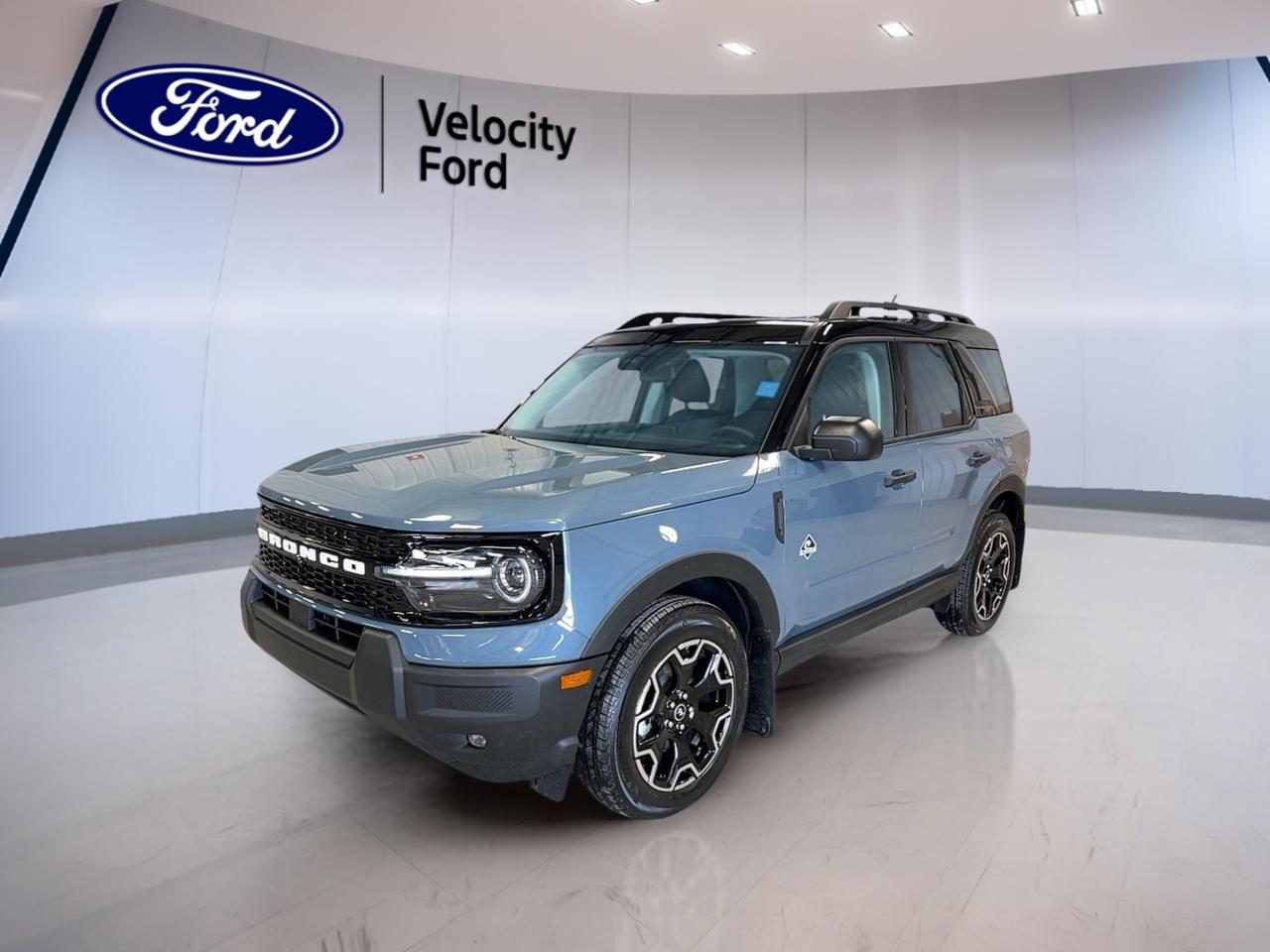 Meet the brand new 2026 Ford Bronco Sport Outer Banks 4x4, now at Velocity Ford in Moose Jaw. Finished in Grey with a Blue interior, this 4-door SUV is built for everyday comfort with the confidence of four-wheel drive. Its 1.5 L gas engine and automatic transmission make it easy to live with, whether youre commuting, running errands, or heading out of town.

This Bronco Sport Outer Banks 4x4 keeps your day simple with smart features you will use often. Remote start helps on cold Saskatchewan mornings, while push-button start adds quick convenience when youre on the go. With heated front seats, dual-zone automatic climate control, and ambient lighting, the cabin feels welcoming in every season.

FEATURES OF THE Bronco Sport Outer Banks 4x4  
»» Four-wheel drive for year-round traction  
»» Remote starter for cold morning comfort  
»» Heated front seats for winter drives  
»» Ambient lighting package for cabin mood  

ADVANCED SAFETY FEATURES  
»» Anti-lock braking system for controlled stops  
»» Stability control helps maintain vehicle balance  
»» Blind spot monitor for safer lane changes  
»» Lane departure warning helps keep course  

PERFORMANCE AND EFFICIENCY  
»» 1.5 L gas engine for daily driving  
»» Automatic transmission for smooth, easy shifts  
»» Power steering for light, precise control  
»» Four-wheel drive adds grip on snow  

COMFORT AND CONVENIENCE  
»» Dual-zone automatic climate control for comfort  
»» Power windows for quick one-touch operation  
»» Driver lumbar support for longer trips  
»» Memory seats store your driving position  

TECHNONOLGY AND CONNECTIVITY  
»» Bluetooth integration for hands-free calling  
»» Steering wheel audio controls within reach  
»» Satellite radio for more listening choice  
»» WiFi hotspot helps keep devices connected  

CARGO SPACE  
»» Rear trunk access makes loading simple  
»» Four-door layout eases passenger entry  
»» Tinted windows help protect items inside  
»» Practical SUV shape supports daily hauling  

WHAT OTHER OWNERS LIKE  
»» Confident visibility from a higher seat  
»» Helpful driver aids for busy traffic  
»» Easy-to-use infotainment and phone pairing  
»» Comfortable ride for daily commuting  

From the LED headlamps and fog lights to the heated mirrors and rear window defroster, this SUV is ready for real Canadian conditions. Add in a backup camera, automatic headlights, and tire pressure monitoring, and you have a Bronco Sport that feels prepared every time you leave the driveway.

This 2026 Ford Bronco Sport Outer Banks 4x4s VIN is: 3FMCR9CN0TRE09923.