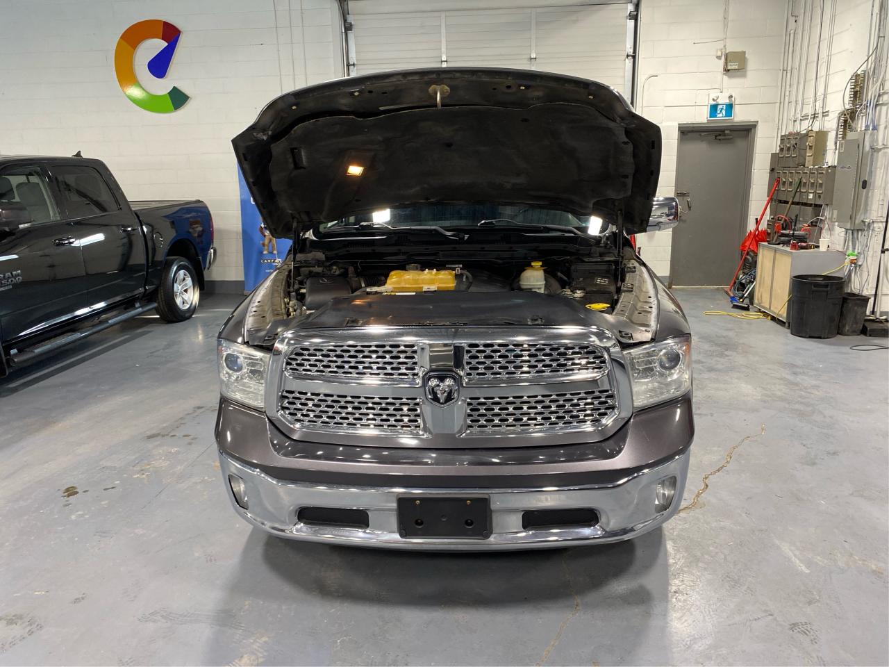 2016 RAM 1500 4WD Quad Cab 140.5" Laramie DIESEL Photo