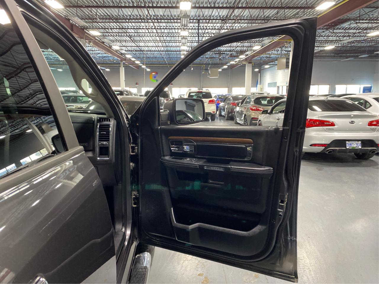 2016 RAM 1500 4WD Quad Cab 140.5" Laramie DIESEL Photo