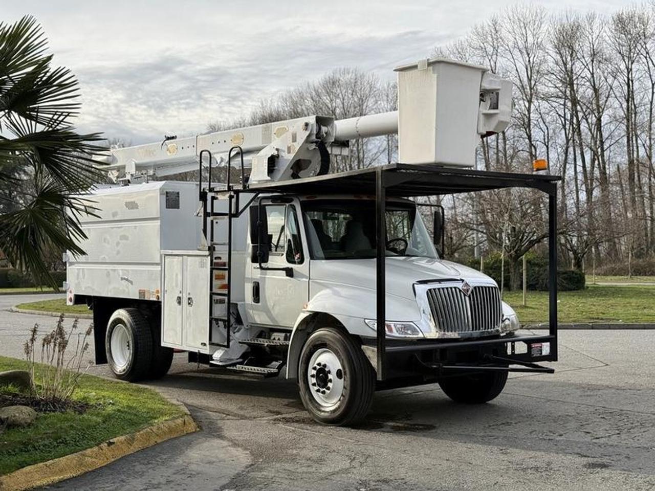 This 2011 International 4300 bucket chipper truck is powered by a 7.6L inline-6 paired with an Eaton Fuller 6-speed manual transmission and rear-wheel drive, and is equipped with hydraulic brakes. It features an Altec LRV56 bucket with a maximum platform height of 56 feet and a 350 lb platform capacity, along with outriggers and a rear hopper. The dump body measures approximately 10 feet long, 6 feet 6 inches wide, and 4 feet 9 inches high, while overall vehicle dimensions are about 30 feet long, 8 feet 1 inch wide, and 12 feet 1 inch high. Additional equipment includes cruise control, air conditioning, AM/FM radio, and a white exterior with a grey vinyl interior, making it well suited for arborist, utility, or fleet operations.  $83,790.00 plus $375 processing fee, $84,165.00 total payment obligation before taxes.   Listing report, warranty, contract commitment cancellation fee, financing available on approved credit (some limitations and exceptions may apply). All above specifications and information is considered to be accurate but is not guaranteed and no opinion or advice is given as to whether this item should be purchased. We do not allow test drives due to theft, fraud, acts of vandalism and undetectable impaired driving. Instead we provide the following benefits: Complimentary Warranty (with options to extend), Limited Money Back Satisfaction Guarantee on Fully Completed Contracts, Contract Commitment Cancellation, and an Open-Ended Sell-Back Option. Ask seller for details or call 604-522-REPO(7376) to confirm listing availability.