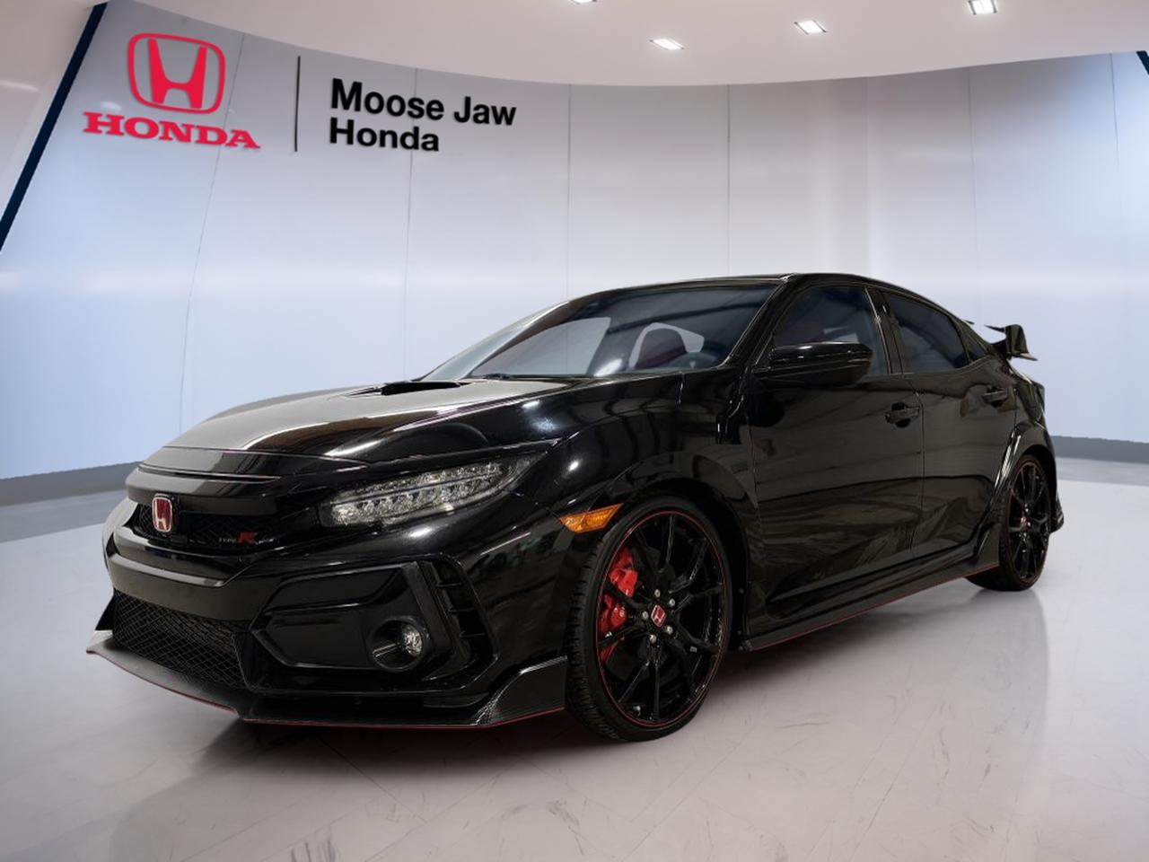 Meet the 2020 Honda Civic Type R Base, a purpose-built performance sedan now available used at Moose Jaw Honda in Moose Jaw. With 50,122 km, this front-wheel-drive icon delivers serious driver engagement in a practical daily package. Its the kind of car that makes every commute feel like a special drive.

Under the hood, the 2020 Honda Civic Type R Base uses a 2.0 L I-4 DOHC 16-valve VTEC turbocharged engine paired to a 6-speed manual transmission with rev-match control. That combination is all about control, timing, and feel. If you want a car that rewards skill and keeps you connected to the road, this is it.

FEATURES OF THE Civic Type R Base
»» Turbocharged 2.0 L VTEC engine
»» 6-speed manual with rev-match control
»» Front-wheel drive performance-focused layout
»» Driver-centred cockpit with sporty controls

ADVANCED SAFETY FEATURES
»» Multiple airbags for occupant protection
»» Anti-lock braking for controlled stops
»» Stability control helps maintain traction
»» Traction control supports slippery conditions

PERFORMANCE AND EFFICIENCY
»» 2.0 L turbocharged four-cylinder power
»» 6-speed manual for full engagement
»» Rev-match control for smoother downshifts
»» Front-wheel drive with confident road feel

COMFORT AND CONVENIENCE
»» Four-door access for daily practicality
»» Supportive seating for longer drives
»» Clear driver-focused gauge layout
»» Easy-to-reach controls reduce distractions

TECHNONOLGY AND CONNECTIVITY
»» Driver information display for key data
»» Integrated audio system for daily listening
»» Steering-wheel controls for quick adjustments
»» Cabin controls designed for simple use

CARGO SPACE
»» Sedan trunk for everyday gear
»» Wide opening for easier loading
»» Room for groceries and travel bags
»» Practical space for daily errands

WHAT OTHER OWNERS LIKE
»» Manual shifting feel and driver involvement
»» Strong turbo pull through the revs
»» Confident handling with front-wheel drive
»» Daily usability with performance personality

This 2020 Honda Civic Type R Bases VIN is: SHHFK8G3XLU300409.