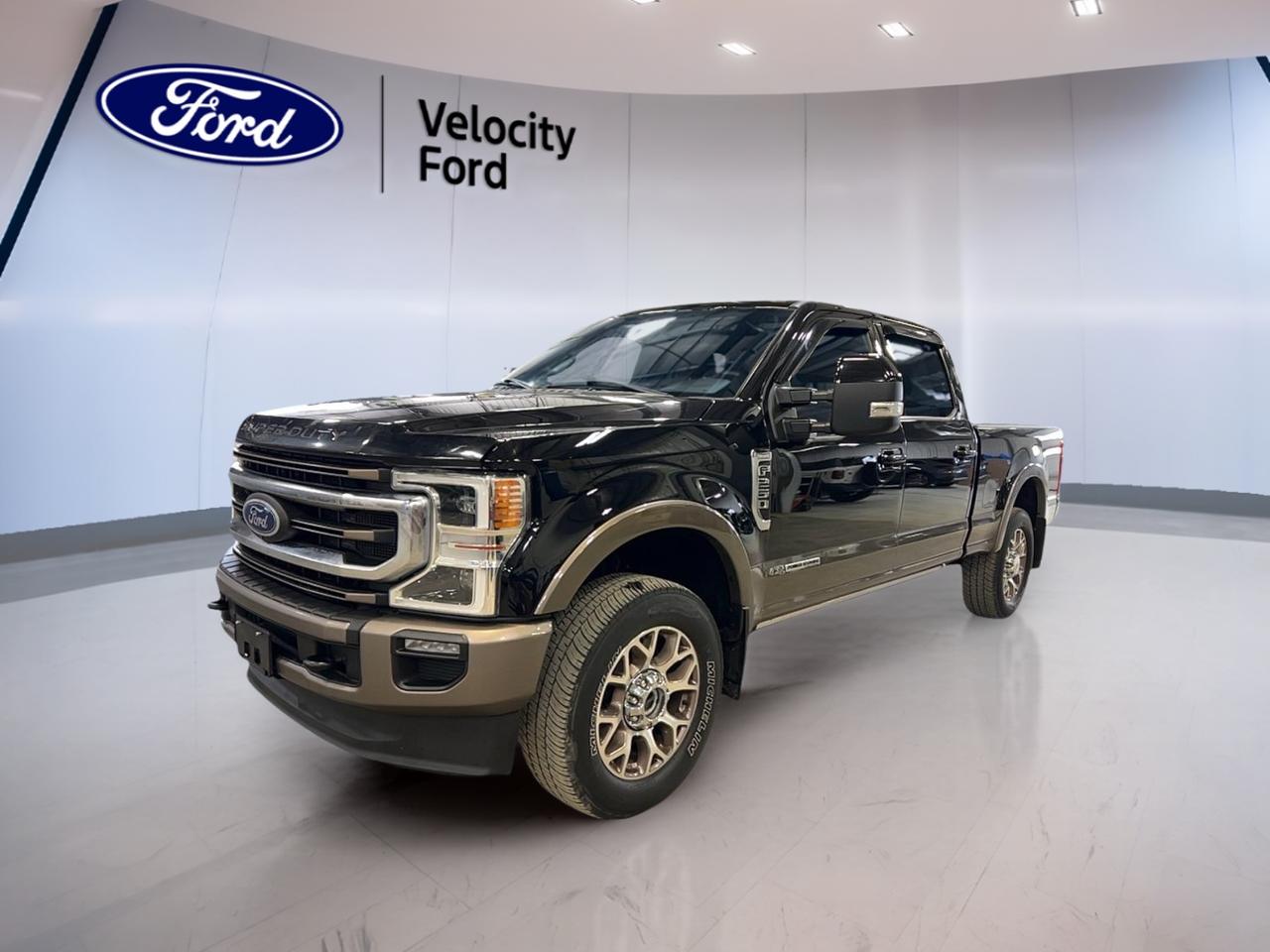 Meet the 2022 Used Ford Super Duty F-250 SRW King Ranch Crew Cab, now offered by Velocity Ford in Moose Jaw. Finished in Black with a Brown interior, this heavy-duty pickup is built for serious work and confident travel, with 100,606 km and a proven 6.7 L diesel engine.

With its automatic transmission and capable 4-door Crew Cab layout, this Used 2022 Ford Super Duty F-250 SRW King Ranch Crew Cab is a smart choice for drivers who need towing strength, winter-ready traction, and everyday comfort in one well-equipped package.

TRUCK FEATURES  
»» 6,576 kg maximum towing capacity  
»» Four-wheel drive for tough conditions  
»» Limited slip differential for better traction  
»» Rear tow hook for recovery needs  

ADVANCED SAFETY FEATURES  
»» Anti-lock braking system for controlled stops  
»» Stability control helps maintain vehicle balance  
»» Driver and passenger airbags for protection  
»» Side impact airbags for added security  

PERFORMANCE AND EFFICIENCY  
»» 6.7 L diesel for strong torque  
»» Automatic transmission with dual shift mode  
»» Four-wheel drive for confident pulling power  
»» Off-road tires for rugged road surfaces  

COMFORT AND CONVENIENCE  
»» Dual-zone automatic climate control comfort  
»» Heated front seats for cold mornings  
»» Heated rear seats for passenger comfort  
»» Power windows and power steering  

TECHNONOLGY AND CONNECTIVITY  
»» Navigation system for clear route guidance  
»» Bluetooth integration for hands-free calling  
»» WiFi hotspot for on-the-go data  
»» Satellite radio and HD Radio  

CARGO SPACE  
»» Rear trunk access for quick loading  
»» Crew Cab space for extra gear  
»» Steps help easier cab entry  
»» Spare tire onboard for peace-of-mind  

WHAT OTHER OWNERS LIKE  
»» Confident towing and hauling capability  
»» Strong diesel performance under load  
»» Four-wheel drive in winter conditions  
»» Useful tech like navigation and Bluetooth  

This Used 2022 Ford Super Duty F-250 SRW King Ranch Crew Cab also brings practical day-to-day features that make a difference in Moose Jaw driving. Enjoy Cruise Control for long highway stretches, a backup camera for easier parking, and a blind spot monitor to support safer lane changes. Automatic headlights, LED headlamps, fog lights, and a rear window defroster help you stay ready when weather turns.

Convenience is well covered with a remote starter, push button start, power mirrors with heating, retractable mirrors, and turn signal mirrors. The cabin adds thoughtful touches like steering wheel audio controls, ambient lighting, memory seats, memory mirrors, adjustable pedals, and an auto-dimming rearview mirror. Tinted windows round out the look while helping with glare and comfort.

This Used 2022 Ford Super Duty F-250 SRW King Ranch Crew Cabs VIN is: 1FT7W2BT2NEF37852.
