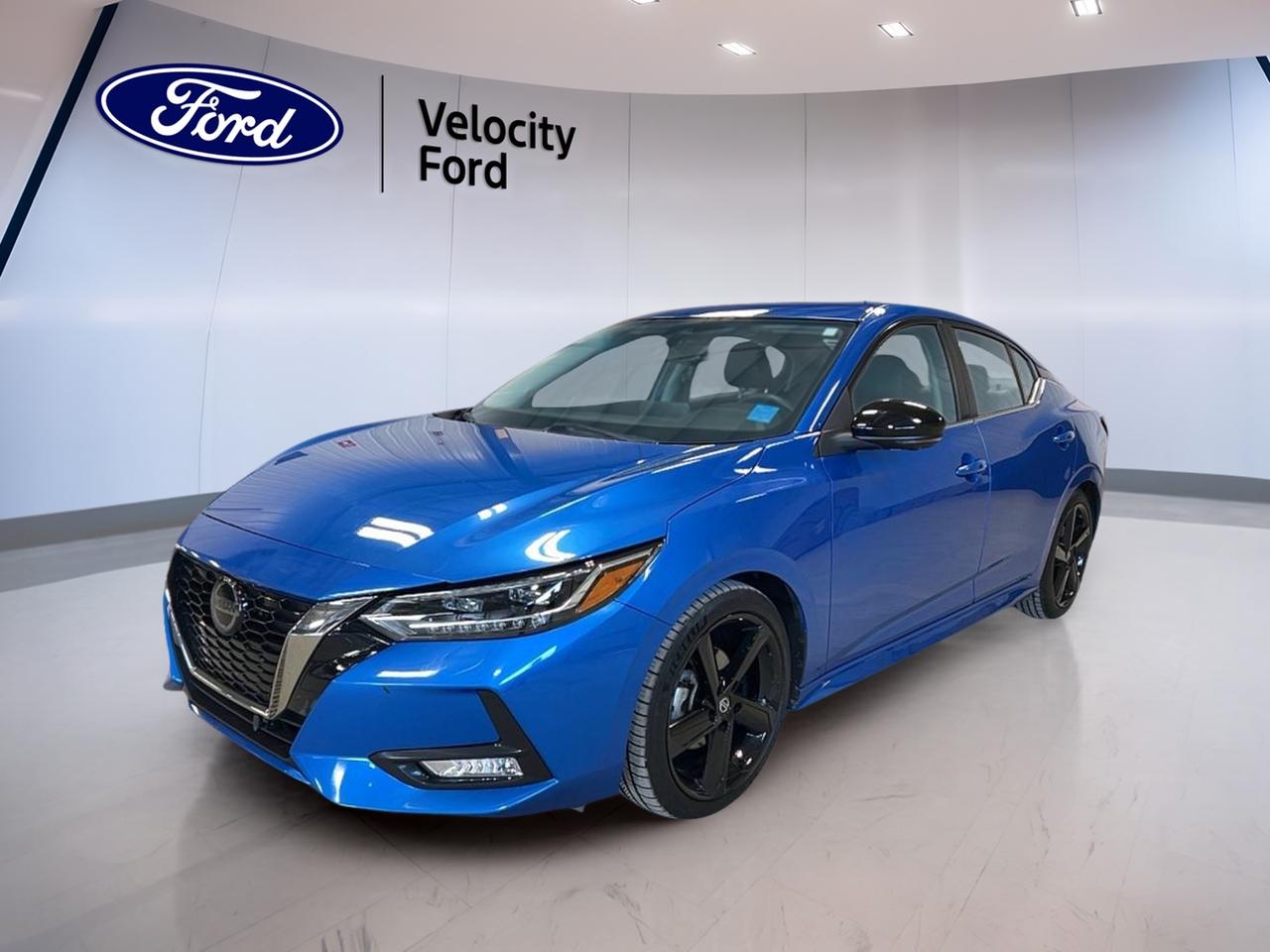 Meet the 2021 Nissan Sentra SR CVT, a smart compact sedan that brings sporty style and everyday comfort together in one easy-to-drive package. This used 4-door sedan is finished in Blue and has 67,770 km. It is offered by Velocity Ford in Moose Jaw, ready for commutes, errands, and weekend drives.

Under the hood, the 2021 Nissan Sentra SR CVT uses a 2.0 L unleaded engine paired with an automatic continuously variable transmission. The drive feel is smooth and relaxed, and front-wheel drive helps keep it confident and efficient in daily Canadian driving. With its rear spoiler, fog lights, and LED headlamps, this sedan looks sharp day or night.

FEATURES OF THE Sentra SR CVT
»» Sporty rear spoiler for added style  
»» Glass sunroof for open-air drives  
»» Heated front seats for cold mornings  
»» Push button start for quick getaways  

ADVANCED SAFETY FEATURES  
»» Anti-lock braking system for controlled stops  
»» Stability control helps maintain traction  
»» Blind spot monitor for safer lane changes  
»» Backup camera for easier reversing  

PERFORMANCE AND EFFICIENCY  
»» 2.0 L unleaded four-cylinder engine  
»» Automatic continuously variable transmission operation  
»» Front-wheel drive for predictable handling  
»» Power steering for light, easy control  

COMFORT AND CONVENIENCE  
»» Dual-zone automatic climate control comfort  
»» Cruise control for relaxed highway driving  
»» Power windows for all-door convenience  
»» Remote starter helps warm up cabin  

TECHNONOLGY AND CONNECTIVITY  
»» Bluetooth integration for hands-free calling  
»» Steering wheel audio controls included  
»» Satellite radio for more listening choice  
»» Push button start adds modern ease  

CARGO SPACE  
»» Rear trunk access for longer items  
»» Remote trunk release from inside cabin  
»» Spare tire included for added confidence  
»» Trunk space suits daily shopping runs  

WHAT OTHER OWNERS LIKE  
»» Comfortable ride for daily commuting  
»» Easy-to-use controls and infotainment  
»» Helpful safety tech like blind spot monitor  
»» Heated seats and remote start convenience  

This 2021 Nissan Sentra SR CVT includes key safety basics like driver and passenger airbags, side impact airbags, and head side airbags, plus child safety locks and a tire pressure monitoring system. Visibility is boosted with automatic headlights, heated mirrors, electric mirrors, and turn signal mirrors. The leather-wrapped steering wheel adds a premium touch, while the illuminated driver and passenger vanity mirrors add convenience at night.

This 2021 Nissan Sentra SR CVTs VIN is: 3N1AB8DV1MY219678.