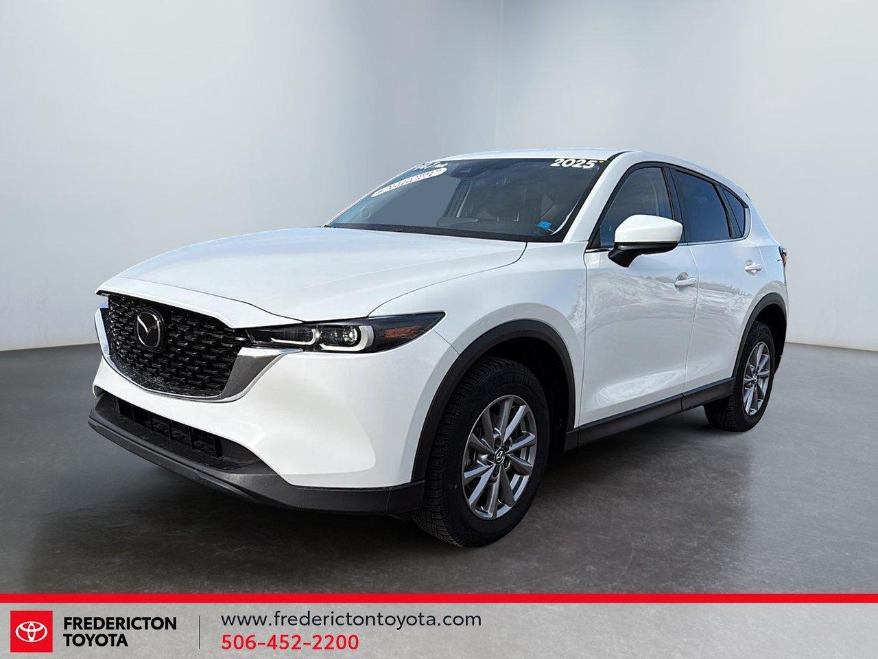 <p data-start=28 data-end=394>The 2025 Mazda CX-5 GS AWD blends sharp styling, confident all-wheel drive capability, and premium comfort into one refined SUV. Enjoy heated front seats and a heated steering wheel for those cold Canadian mornings, dual-zone climate control, power driver seat with lumbar support, leather-wrapped steering wheel, and a power liftgate for everyday convenience.

<p data-start=396 data-end=871>Stay connected with Bluetooth, HD Radio, smart device integration, and a crisp back-up camera. Advanced safety features include Blind Spot Monitoring, Lane Keeping Assist, Adaptive Cruise Control, Front Collision Mitigation, Automatic High Beams, and Stability Control &mdash; giving you confidence on every drive. With rain-sensing wipers, LED headlights with auto-leveling, and stylish aluminum wheels, this CX-5 delivers comfort, technology, and capability in one sleek package.

<p data-start=873 data-end=1072 data-is-last-node= data-is-only-node=>Why choose to buy from Fredericton Toyota? When you buy from us, you&rsquo;re not just a customer. You&rsquo;re part of the family, and we&rsquo;re committed to providing exceptional service every step of the way.