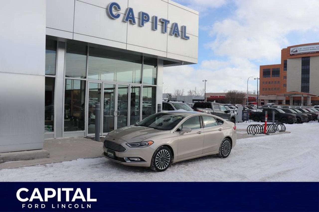 This WHITE GOLD AWD Fusion Titanium responds to all your needs! It has a fuel-efficient Intercooled Turbo Regular Unleaded I-4 2.0 L/122 engine and 6-speed select-shift automatic transmission. The push-button start is as easy as pushing a button when you get in to start your vehicle. So convenient! It has a voice activated Ford SYNC system that delivers hands-free calls, reads text messages aloud, and you can play music from your smart phone with Bluetooth capability! Wow! The 8 colour LCD touch screen is easy to control your phone, entertainment, climate and more. Entering the vehicle is super easy and convenient with the keyless entry keypad. The award winning exterior design has stylish 18 wheels that are silver painted aluminum. It includes an AM/FM stereo, a CD player with MP3 capability, USB port, audio input jack and 911 assist. When backing up, a rear vision camera is conveniently displayed on the LCD screen, giving you a heads-up of whats behind you. Contact us today to test drive this Ford Fusion Titanium!Check out this vehicles pictures, features, options and specs, and let us know if you have any questions. Helping find the perfect vehicle FOR YOU is our only priority.P.S...Sometimes texting is easier. Text (or call) 1-204-900-8266 for fast answers at your fingertips!Dealer Permit #4697