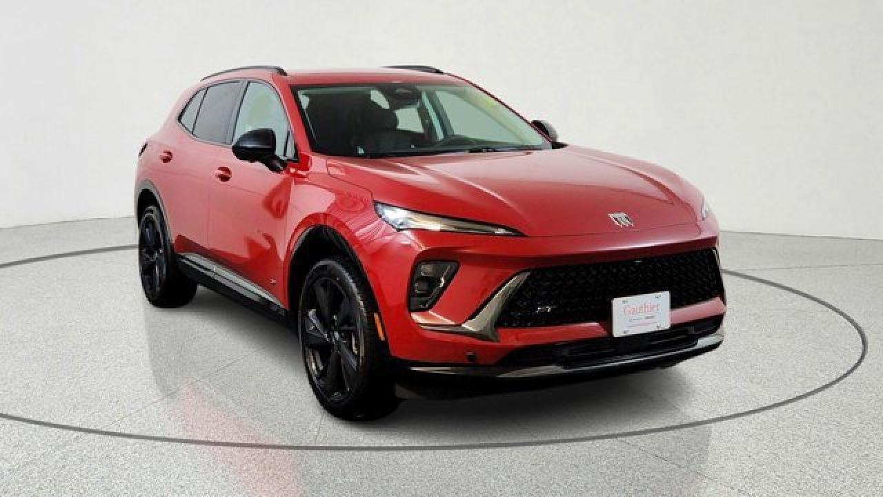 The 2026 Buick Envision Sport Touring delivers athletic styling and premium amenities. Its powered by a 2.0-liter turbocharged 4-cylinder engine paired with a 9-speed automatic transmission and standard all-wheel drive, riding on 20-inch alloy wheels with dark-gloss accents for a more aggressive look. Inside, the cabin features a large 30-inch ultrawide display, heated front seats, a Bose premium sound system, adaptive cruise control, lane-keeping assistance, and a panoramic power moonroof that brings in extra light and openness.