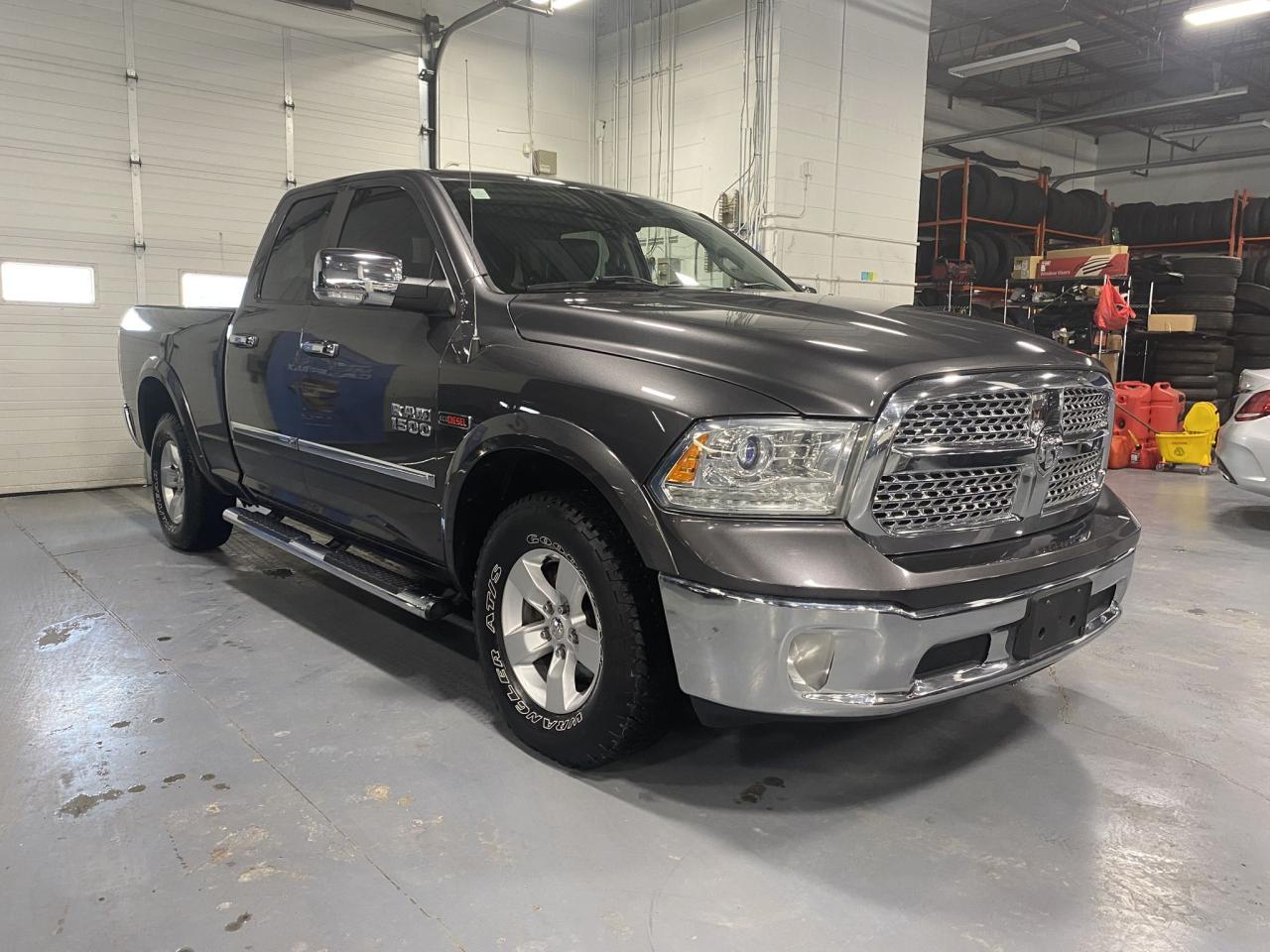 2016 RAM 1500 4WD Quad Cab 140.5" Laramie Photo2
