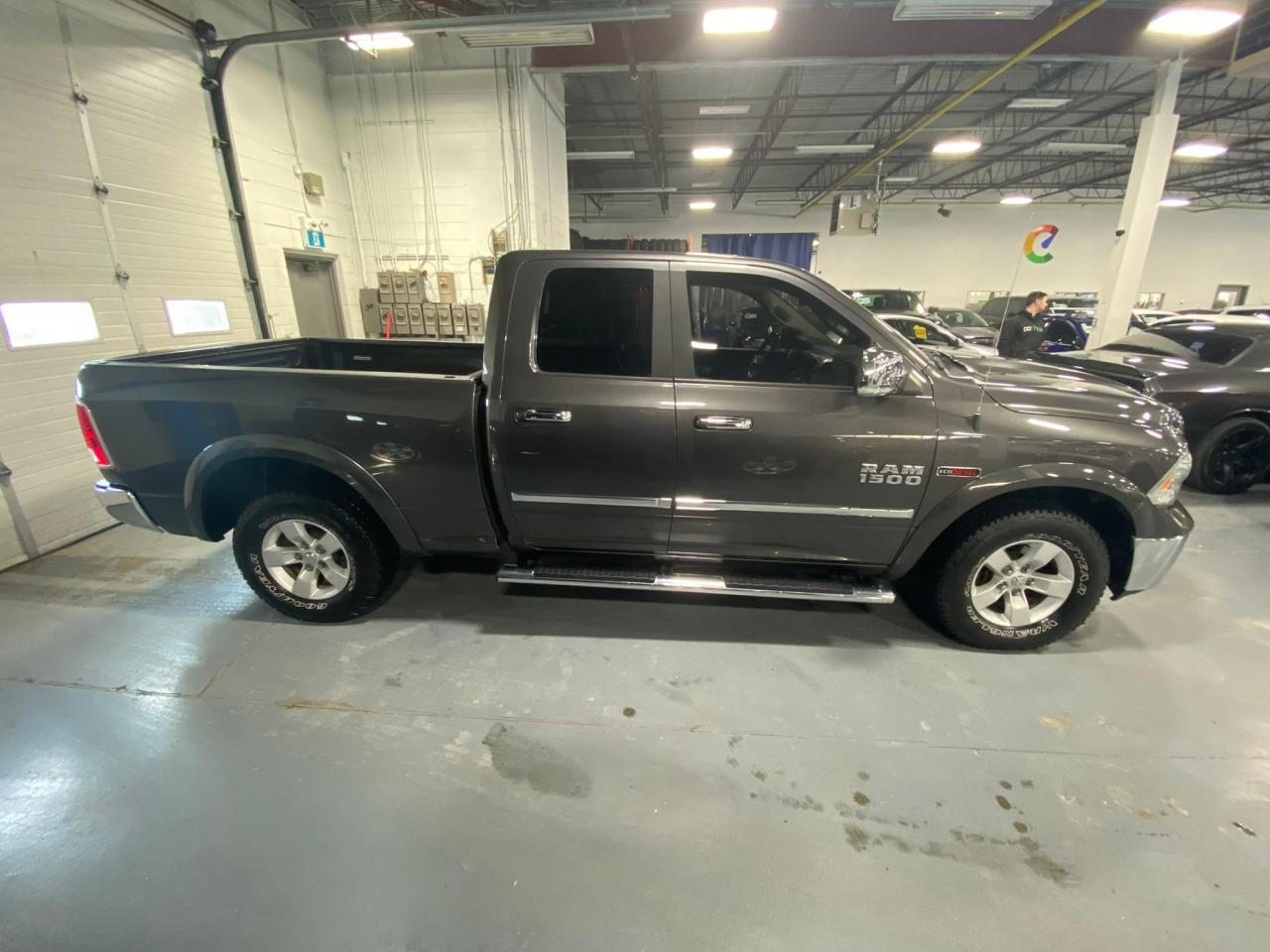 2016 RAM 1500 4WD Quad Cab 140.5" Laramie Photo3