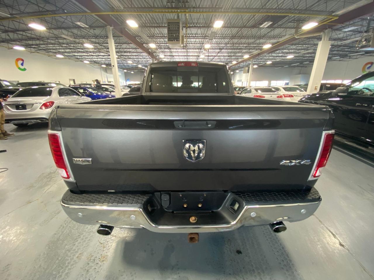 2016 RAM 1500 4WD Quad Cab 140.5" Laramie Photo