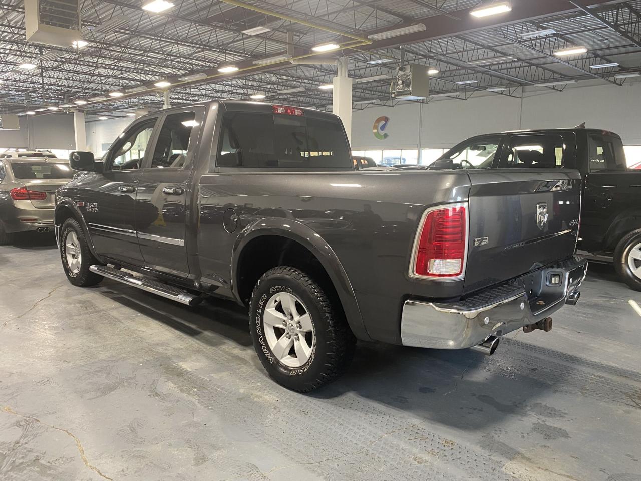 2016 RAM 1500 4WD Quad Cab 140.5" Laramie Photo