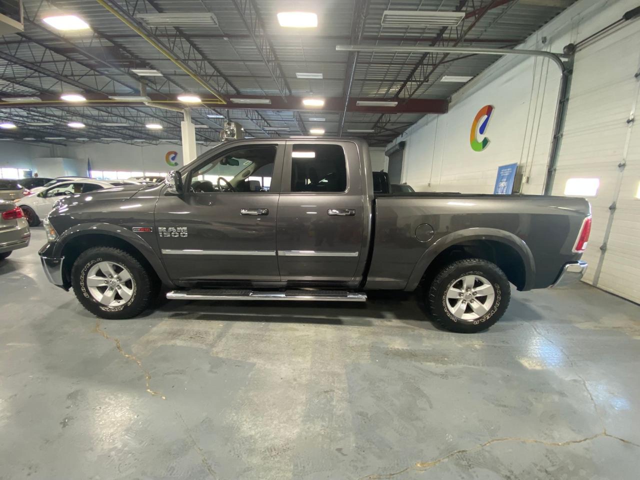 2016 RAM 1500 4WD Quad Cab 140.5" Laramie Photo