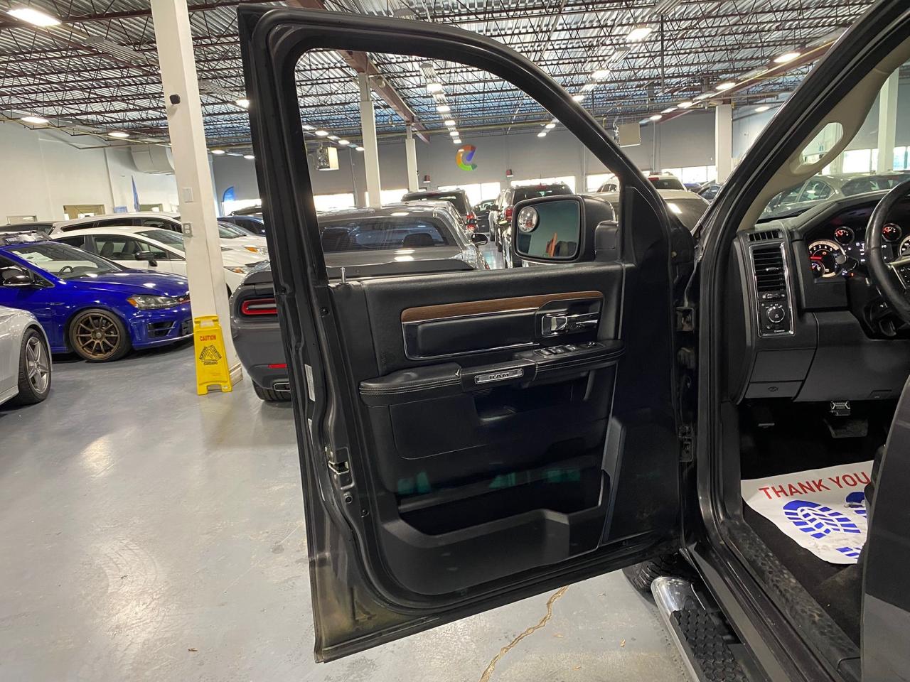 2016 RAM 1500 4WD Quad Cab 140.5" Laramie Photo