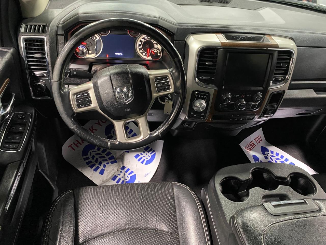 2016 RAM 1500 4WD Quad Cab 140.5" Laramie Photo