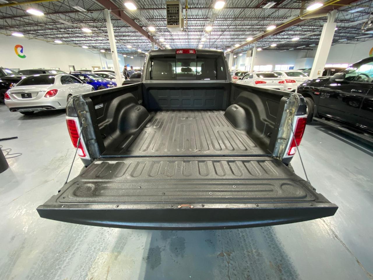 2016 RAM 1500 4WD Quad Cab 140.5" Laramie Photo