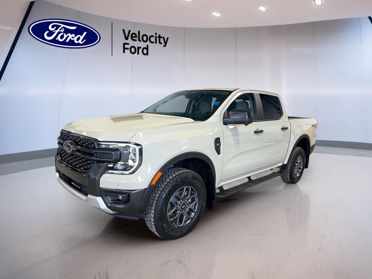 Meet the brand new 2026 Ford Ranger XLT SuperCrew at Velocity Ford in Moose Jaw, finished in Desert Sand (VA) with a Beige interior. This 4-door truck pairs a 2.3-litre gas engine with an automatic transmission for smooth, easy driving in town and on the highway.

Built for real work and real weekends, the 2026 Ford Ranger XLT SuperCrew brings confident capability with four-wheel drive and off-road tires for added grip when the road turns rough. With a towing capacity of 3,400 kg, its ready for trailers, toys, and jobsite needs, while still staying comfortable and simple to live with every day.

TRUCK FEATURES  
»» Towing capacity rated at 3,400 kg  
»» Four-wheel drive for confident traction  
»» Rear tow hook for recovery help  
»» Off-road tires for tougher terrain  

ADVANCED SAFETY FEATURES  
»» Anti-lock braking system helps maintain steering  
»» Stability control supports control in corners  
»» Blind spot monitor helps change lanes  
»» Lane departure warning adds extra awareness  

PERFORMANCE AND EFFICIENCY  
»» 2.3-litre gas engine for balanced power  
»» Automatic transmission for smooth daily driving  
»» Dual shift mode for manual control  
»» Power steering for easy low-speed turns  

COMFORT AND CONVENIENCE  
»» Front air conditioning for cabin comfort  
»» Power windows for quick one-touch control  
»» Remote starter for ready-to-go mornings  
»» Driver lumbar support eases long drives  

TECHNONOLGY AND CONNECTIVITY  
»» Navigation system helps plan every route  
»» Bluetooth integration for hands-free calling  
»» WiFi hotspot helps keep devices connected  
»» Steering wheel audio controls reduce distraction  

CARGO SPACE  
»» Four-door cabin supports crew and gear  
»» Spare tire included for roadside confidence  
»» Tinted windows help reduce glare inside  
»» Rear window defroster improves cold visibility  

WHAT OTHER OWNERS LIKE  
»» Easy-to-use driver-assist safety technology  
»» Confident traction from four-wheel drive  
»» Useful towing strength for weekend plans  
»» Clear backup camera while parking  


This 2026 Ford Ranger XLT SuperCrews VIN is: 1FTER4HHXTLE03841.