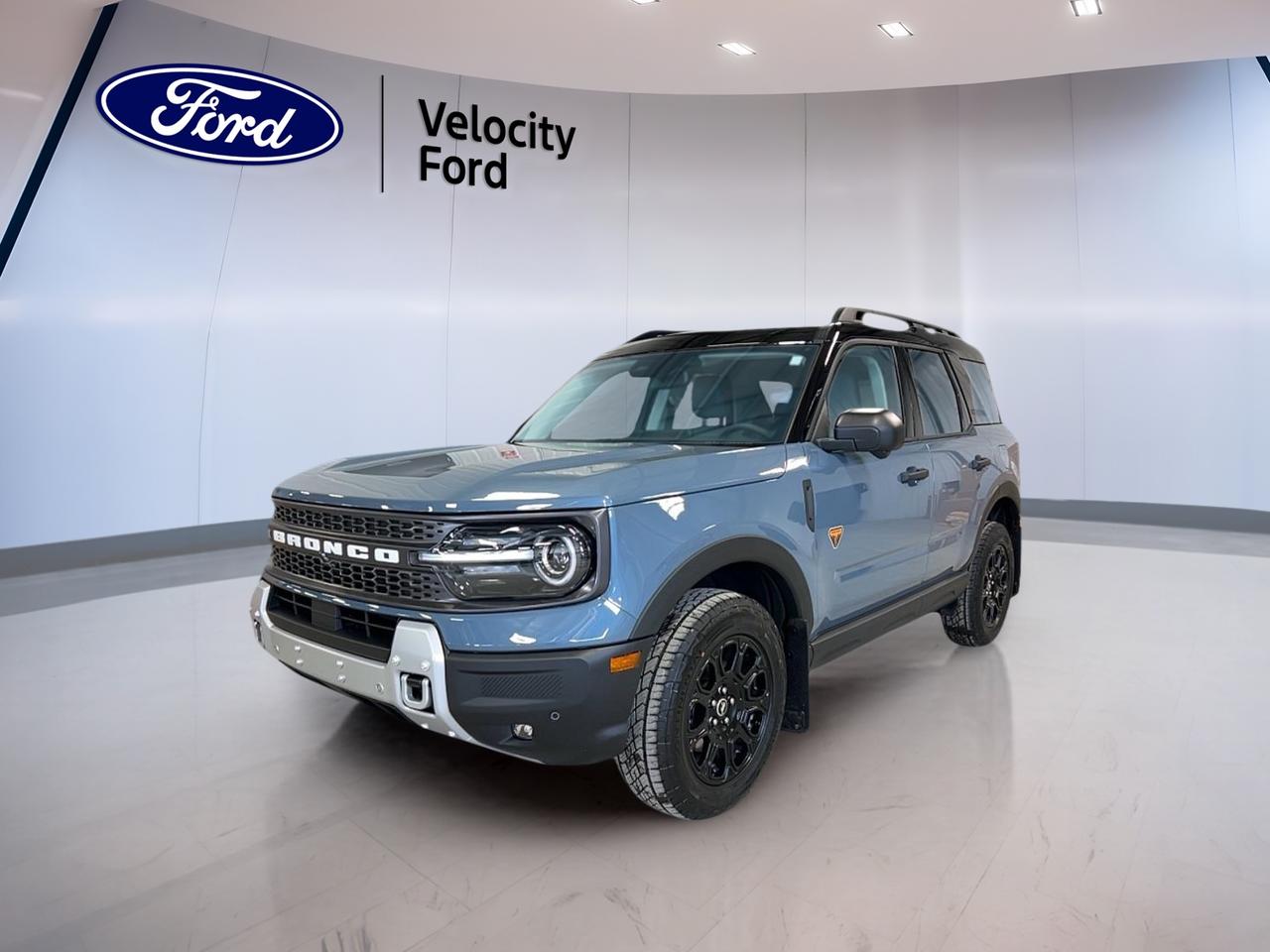 Meet the brand new 2026 Ford Bronco Sport Badlands at Velocity Ford in Moose Jaw, ready for drivers who want real capability with everyday comfort. Finished in Grey with a Dark grey interior, this 4-door SUV brings a confident stance, smart safety tech, and useful features for Saskatchewan roads year-round.

With a 2.0-litre gas engine and an 8-speed automatic transmission, this 2026 Ford Bronco Sport Badlands is built to feel smooth in town and sure-footed when conditions change. Add Four-Wheel Drive (4WD), off-road tires, and a rear tow hook, and you have a Bronco Sport thats prepared for gravel, snow, and weekend escapes.

ADVANCED SAFETY FEATURES  
»» Anti-Lock Braking System for controlled stops  
»» Stability Control helps maintain confident handling  
»» Blind Spot Monitor for safer lane changes  
»» Lane Departure Warning adds extra awareness  

PERFORMANCE AND EFFICIENCY  
»» 2.0-litre gas engine for strong response  
»» 8-speed automatic transmission shifts smoothly  
»» Four-Wheel Drive for confident all-weather traction  
»» Limited Slip Differential improves grip off-road  

COMFORT AND CONVENIENCE  
»» Dual-zone automatic climate control for comfort  
»» Heated front seats for cold mornings  
»» Remote starter for pre-warmed departures  
»» Power windows and power steering included  

TECHNONOLGY AND CONNECTIVITY  
»» Bluetooth Integration for hands-free calling  
»» WiFi Hotspot helps keep devices connected  
»» Satellite Radio for more listening choice  
»» Steering wheel audio controls within easy reach  

CARGO SPACE  
»» Rear trunk access makes loading simple  
»» Spare tire included for added reassurance  
»» Four-door layout eases passenger entry  
»» Tinted windows help protect interior items  

WHAT OTHER OWNERS LIKE  
»» Confident traction from Four-Wheel Drive system  
»» Useful safety tech for daily commuting  
»» Remote start convenience in winter weather  
»» Comfortable driving position and easy controls  

This 2026 Ford Bronco Sport Badlands is also well equipped with practical details that make a difference every day. Enjoy a backup camera for easier parking, automatic headlights and LED headlamps for clear visibility, and fog lights for poor weather. Heated mirrors and electric mirrors help keep your view clear, while an auto-dimming rearview mirror reduces glare at night.

Inside, this 2026 Ford Bronco Sport Badlands adds thoughtful touches like ambient lighting, push button start, and memory settings for the drivers seat and mirrors. You also get drivers seat lumbar support, an adjustable steering wheel, and driver and passenger vanity mirrors with illumination. Safety coverage includes driver and passenger airbags, side impact airbags, head side airbags, and a passenger airbag sensor, plus child safety locks for family peace of mind.

This 2026 Ford Bronco Sport Badlandss VIN is: 3FMCR9DA2TRE09241.