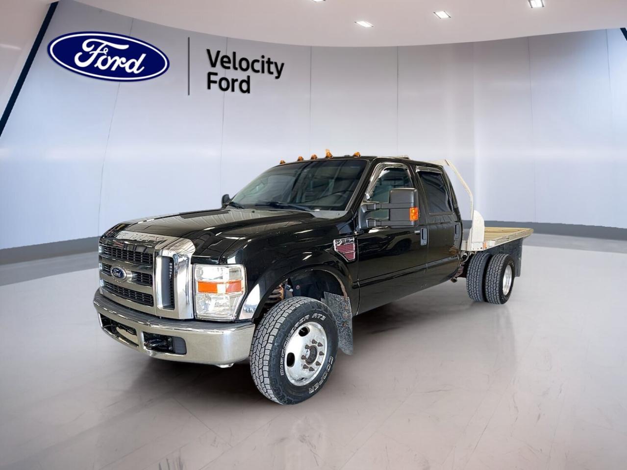 Built for serious work and confident winter driving, this used 2008 Ford Super Duty F-350 DRW XLT Crew Cab is ready for Moose Jaw roads and job sites alike. With a Black exterior, Beige interior, and 4 full doors, it brings true heavy-duty presence with everyday practicality. This truck shows 255,985km and is offered by Velocity Ford.

Under the hood, the 2008 Ford Super Duty F-350 DRW XLT Crew Cab is powered by a 6.4 L OHV direct-injection 32-valve V8 Power Stroke turbo-diesel engine. Paired with an automatic transmission and Four-Wheel Drive (4WD), its set up for confident traction when conditions change. Dual rear wheels add stability and control when the load gets serious.

FEATURES OF THE Super Duty F-350 DRW XLT Crew Cab  
»» Crew Cab with four full doors  
»» Dual rear wheels for added stability  
»» Power Stroke turbo-diesel V8 power  
»» Four-wheel drive for tough conditions  

TRUCK FEATURES  
»» Dual rear wheels for steadier hauling  
»» Rear tow hook for recovery points  
»» Spare tire included for jobsite readiness  
»» Rear trunk access for easier loading  

ADVANCED SAFETY FEATURES  
»» Anti-lock braking system for controlled stops  
»» Driver airbag for front impact protection  
»» Passenger airbag for added front safety  
»» Passenger airbag sensor helps manage deployment  

PERFORMANCE AND EFFICIENCY  
»» 6.4 L Power Stroke turbo-diesel V8  
»» Automatic transmission for smoother power delivery  
»» Four-wheel drive for confident traction  
»» Power steering for easier low-speed control  

COMFORT AND CONVENIENCE  
»» Front air conditioning for cabin comfort  
»» Cruise control for relaxed highway driving  
»» Power windows for quick one-touch control  
»» Adjustable steering wheel for better fit  

TECHNONOLGY AND CONNECTIVITY  
»» Satellite radio for more listening choice  
»» Power outlet for charging small devices  
»» Electric mirrors for easy adjustments  
»» Automatic door lock for added security  

CARGO SPACE  
»» Crew Cab space for tools and gear  
»» Rear trunk access for easier loading  
»» Dual rear wheels support heavier payloads  
»» Steel wheels built for work durability  

WHAT OTHER OWNERS LIKE  
»» Strong diesel pull under heavy loads  
»» Stable feel from dual rear wheels  
»» Four-wheel drive confidence in winter  
»» Simple, durable controls and layout  

This 2008 Ford Super Duty F-350 DRW XLT Crew Cabs VIN is: 1FTWW33R48ED21932.