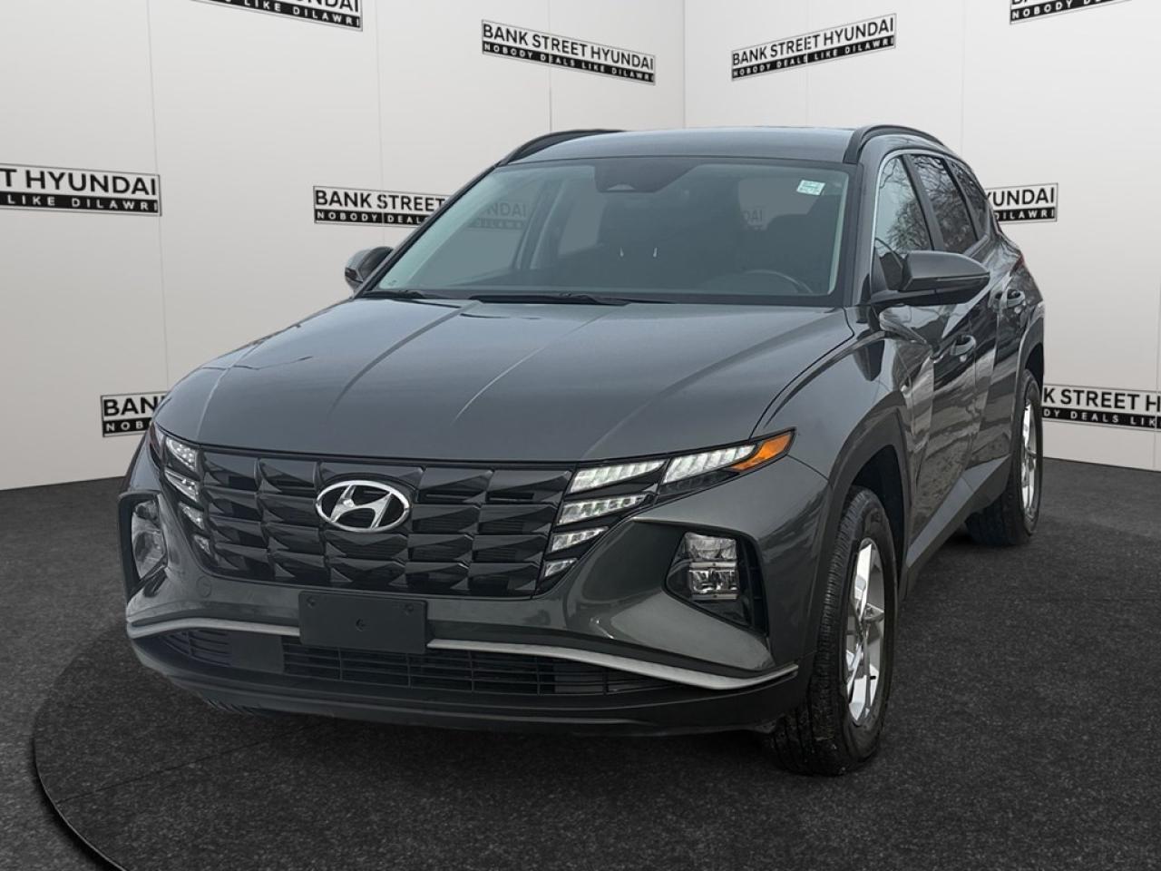 The 2023 Hyundai Tucson Preferred AWD in a sophisticated gray finish offers exceptional handling with its all-wheel-drive system, making it a versatile choice for Canadian roads. This SUV boasts a modern exterior with eye-catching alloy wheels and sleek lines that enhance its road presence. Inside, youll find a well-appointed cabin with comforts such as heated seats, a leather steering wheel, and a heated steering wheel for those chilly mornings. Equipped with the latest technology, this Tucson features a user-friendly backup camera, Bluetooth connection, and smart device integration to keep you connected on the go. Safety takes priority with advanced features like lane assist and adaptive cruise control, providing peace of mind wherever your adventures take you. Whether youre a busy family, a commuter, or someone who craves both style and substance in their vehicle, the Hyundai Tucson has something to offer. Contact our dealership today to learn more and take this impressive SUV for a test drive.