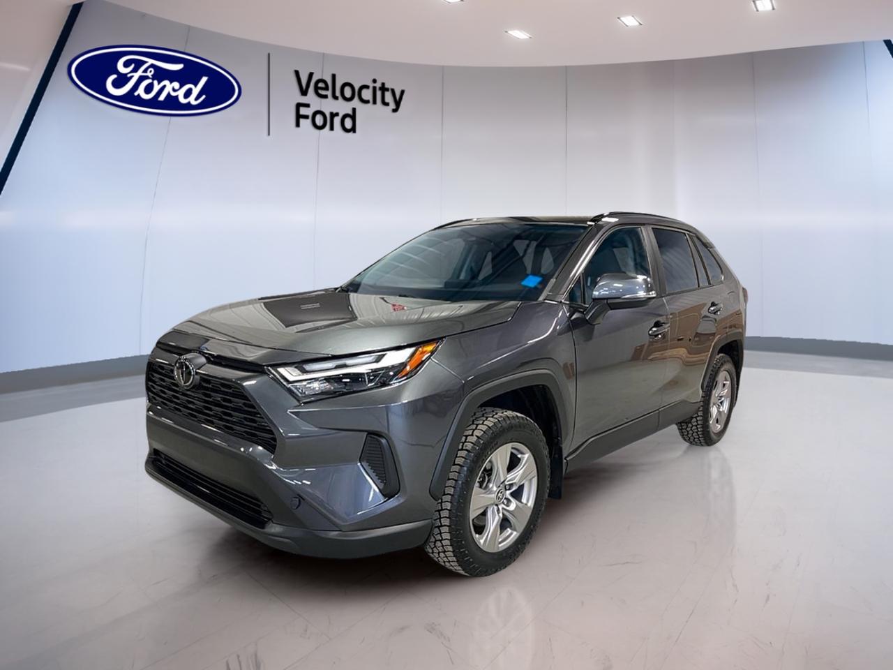 Meet a smart, capable compact SUV that fits life in Saskatchewan with ease. This used 2023 Toyota RAV4 XLE AWD, offered by Velocity Ford in Moose Jaw, pairs confident all-wheel-drive traction with everyday comfort and practical tech. Finished in grey with 4 doors, its ready for commuting, errands, and weekend plans.

Powered by a 2.5 L gas engine and an 8-speed automatic transmission, this 2023 Toyota RAV4 XLE AWD delivers smooth, easy acceleration and calm highway manners. With 101,523 km, it has already proven it can handle real-world driving while still offering the modern features drivers want for year-round convenience.

FEATURES OF THE RAV4 XLE AWD  
»» All-wheel drive for four-season confidence  
»» Power liftgate for easier loading  
»» Dual-zone automatic climate control comfort  
»» Glass sunroof for open-air feel  

ADVANCED SAFETY FEATURES  
»» Anti-lock braking system for controlled stops  
»» Stability control helps maintain steady handling  
»» Blind spot monitor for safer lane changes  
»» Lane departure warning adds extra awareness  

PERFORMANCE AND EFFICIENCY  
»» 2.5 L gas engine for daily driving  
»» 8-speed automatic transmission shifts smoothly  
»» Dual shift mode for more control  
»» Power steering for easy low-speed turns  

COMFORT AND CONVENIENCE  
»» Heated front seats for cold mornings  
»» Dual-zone climate control for balanced comfort  
»» Driver power seat with lumbar support  
»» Push button start for quick getaways  

TECHNONOLGY AND CONNECTIVITY  
»» Bluetooth integration for calls and audio  
»» Steering wheel audio controls within reach  
»» Satellite radio for more listening choice  
»» WiFi hotspot helps keep devices connected  

CARGO SPACE  
»» Power liftgate for hands-free style access  
»» Rear trunk access for quick loading  
»» Cargo cover helps keep items out-of-sight  
»» Spare tire included for added reassurance  

WHAT OTHER OWNERS LIKE  
»» Confident all-wheel drive in bad weather  
»» Easy visibility with backup camera  
»» Comfortable ride for daily commuting  
»» Practical cargo area for busy weeks  

This RAV4 keeps the details that matter close at hand. Youll appreciate the backup camera for tight parking spots, automatic headlights for changing light, and heated mirrors with power-adjustable mirrors for clearer winter visibility. Tinted windows and a rear spoiler add a clean, sporty finish without sacrificing practicality.

For day-to-day ease, this SUV includes power windows, automatic door locks, remote trunk release, and a remote starter to help warm things up before you head out. With a leather-wrapped steering wheel, ambient lighting package, and illuminated vanity mirrors, the cabin feels thoughtful and driver-focused.

This 2023 Toyota RAV4 XLE AWDs VIN is: 2T3R1RFV0PC329977.
