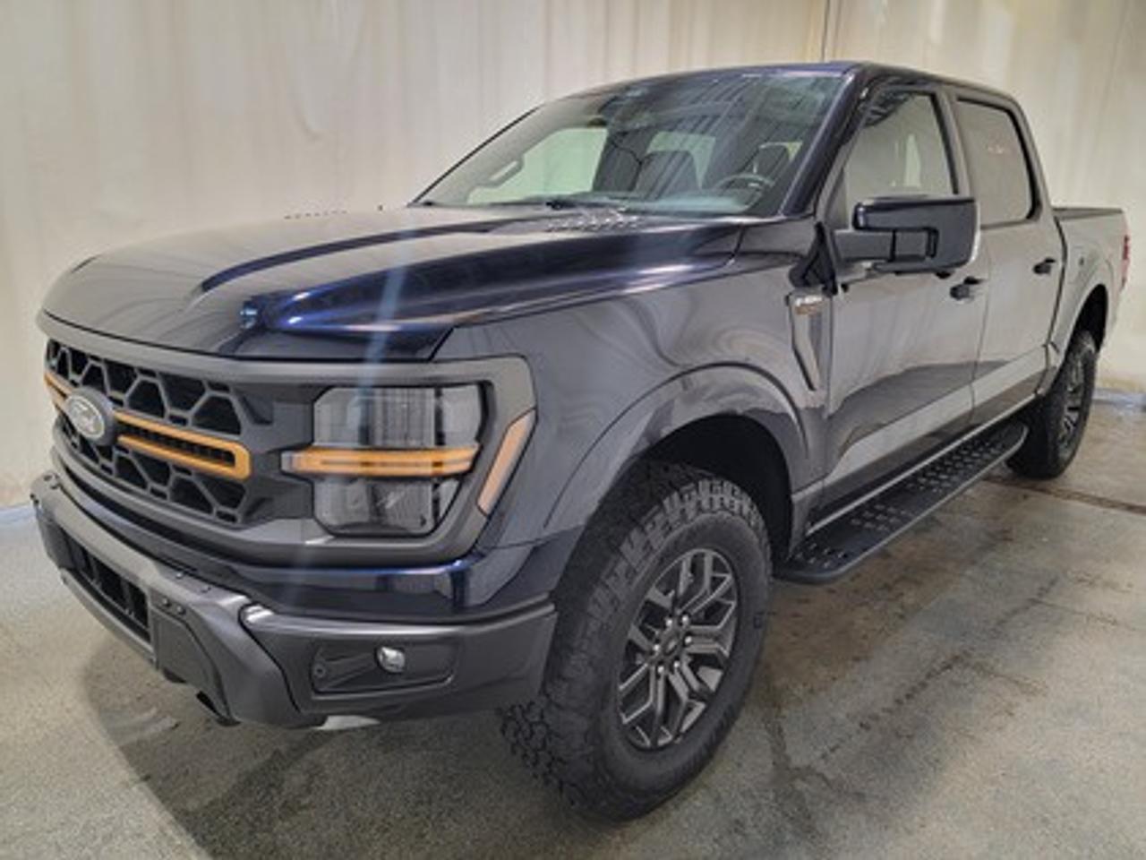 The all-new 2025 Ford F-150 Tremor 402A showcased in Antimatter Blue Metallic. This truck is equipped with the high-performance 3.5L V6 EcoBoost engine, producing 400 horsepower and 500 lb-ft of torque. With its 10-speed automatic transmission, also delivering a combined highway/city fuel economy of 12.9L/100km (22 miles per gallon).

This vehicle comes with the All-Weather Packageready to take on any season! 

Snow, rain, mud, or sunshinethis vehicle is built for it all! The All-Weather Package adds extra protection where it matters most, with premium mud flaps to shield your paint from road debris, all-weather floor mats to protect your interior from lifes messes, and Xpel paint protection to help guard against those infuriating rock chips. Drive with confidence, knowing your investment is protected from Regina's elements. 

Key Features:
Bed Utility Package
Mobile Office Package
Tow/Haul Package
Front Axle W/Torsen Differential
Selectable Drive Modes
18 Alloy W/ Dark Matte Finish Wheels
Heated Front Seats & Rear Seats
Ford Co-Pilot 360 Assist 2.0
Adaptive Cruise Control
Lane Centering
Evasive Steering Assist
Front Parking Sensors
Pro Trailer Backup Assist
Pro Trailer Hitch Assist
14 Speaker B&O Unleashed Sound System
Hill Descent Control
Remote Start System
Twin Panel Moonroof

The 2026 F-150 Tremor 402A is built to conquer Saskatchewans toughest terrain, offering superior off-road capability, advanced technology, and premium comfort. Whether youre tackling backcountry trails or towing with confidence, this truck ensures a smooth ride with heavy-duty off-road shocks, unique Tremor control arms, and selectable drive modes, including Rock Crawl mode. 

Bennett Dunlop Ford, proudly serving Regina for over 40 years, is conveniently located at 770 Broad Street. With over 3,500 Google reviews, our reputation reflects our commitment to providing a fast, easy, and enjoyable vehicle-buying experience. We eliminate the hassle with no admin or documentation fees, transparent upfront pricing that lets you shop with total confidence. But were more than just a dealershipwere driven to make a difference by supporting local community initiatives and events that matter to you. Visit Bennett Dunlop Ford today and experience why were Reginas trusted choice for quality vehicles, exceptional service, and a genuine commitment to driving change in our community!