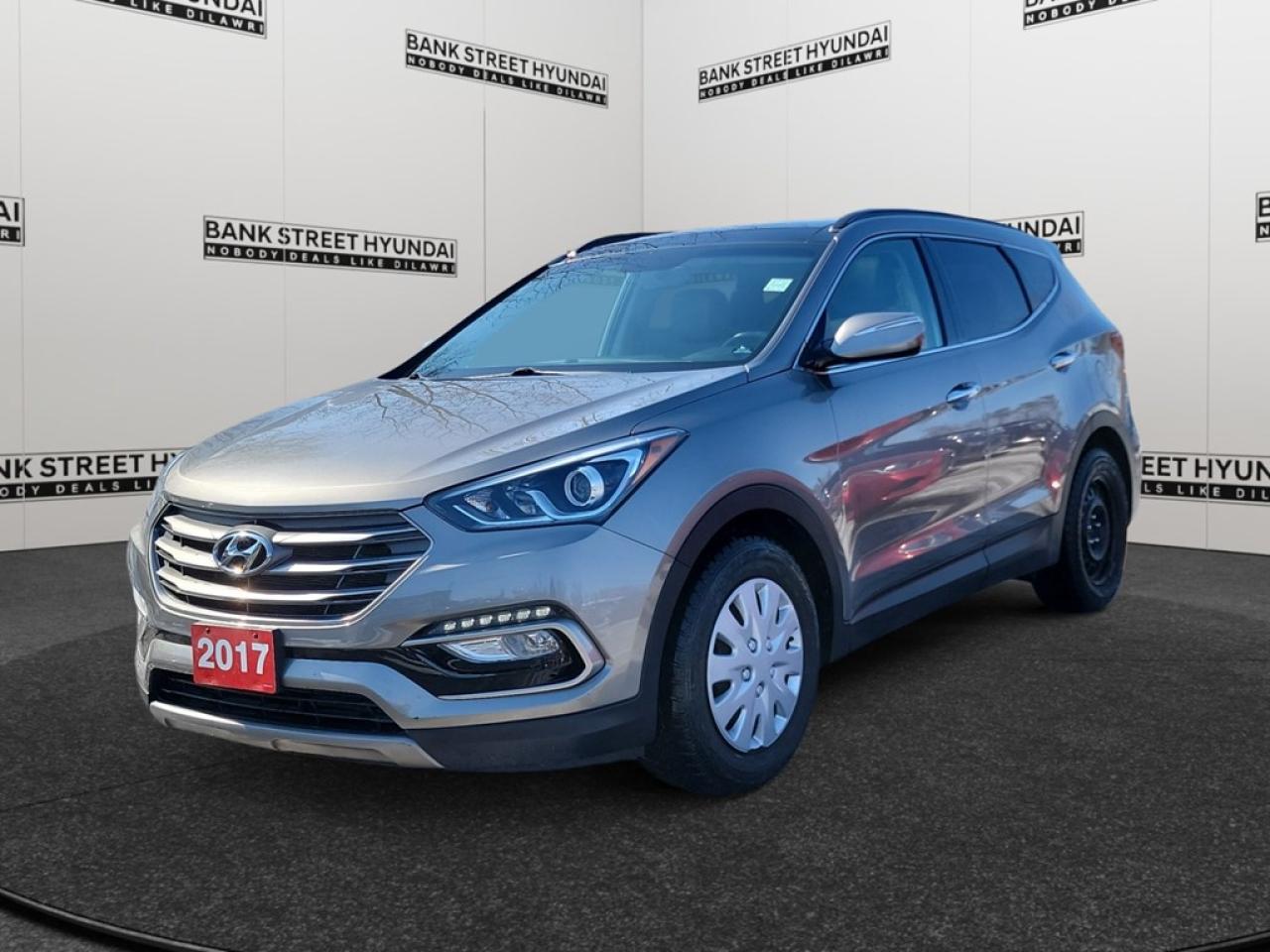 The 2017 Hyundai Santa Fe Sport Luxury AWD in a sophisticated gray finish is a dynamic and accommodating SUV designed for those who crave both comfort and performance. Equipped with a capable AWD drivetrain, this vehicle ensures a confident driving experience whether youre navigating urban streets or venturing off the beaten path. The elegant exterior is matched with a spacious and thoughtfully designed interior featuring leather seats and a leather/piano black gear shifter. Enjoy the convenience of a power sunroof/moonroof that enhances the cabins airy feel. The alloy wheels add a touch of refinement, and the heated mirrors are perfect for those chilly Canadian mornings. Inside, the Santa Fe Sport is packed with technology including a user-friendly navigation system, smart device integration, and a comprehensive suite of safety features such as lane assist, parking sensors, and a backup camera. With heated front and rear seats, a leather steering wheel, and a heated steering wheel, every journey is comfortable and enjoyable. The air conditioning, Bluetooth connection, and satellite radio ensure that youre set for long drives. Perfectly tailored for families and driving enthusiasts alike, this SUV combines practicality with luxury. Whether youre a professional on-the-go or a parent seeking a reliable family vehicle, the Santa Fe Sport will exceed your expectations. Contact our dealership today to experience this exceptional vehicle and learn more about what it offers.