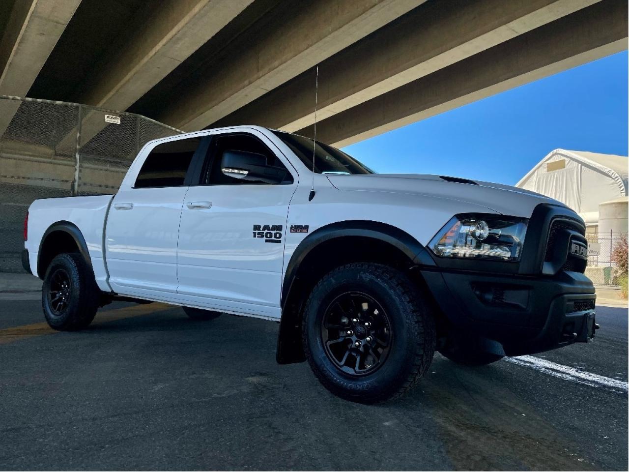 RAM 1500 SLT CREW CAB 4X4 
Exterior Color: Bright White Interior Color: Black interior / Black seats 
Interior: Cloth front 40/20/40 split bench seat Engine: 5.7L HEMI VVT V8 engine with FuelSaver MDS Transmission: 8speed TorqueFlite automatic transmission 
STANDARD EQUIPMENT (UNLESS REPLACED BY OPTIONAL EQUIPMENT)
Advanced multistage front air bags
Supplemental side curtain air bags
Supplemental side air bags
Supplemental front seatmounted side air bags
ParkView Rear BackUp Camera
4wheel antilock disc brakes
Electronic Stability Control
Tire pressure monitoring system
Automatic headlamps
4pin wiring harness
Engine block heater
730amp maintenancefree battery
12volt auxiliary power outlet
Air conditioning
Cruise control
Power windows with front 1touch up and down
SiriusXM satellite radio with 1year subscription
Handsfree phone communication
OPTIONAL EQUIPMENT (May Replace Standard Equipment)
Customer Preferred Package 27F $2,995
Bpillar blackout 
Warlock Package 
Black exterior badging 
Black Rams head tailgate badge 
Black grille with Ram lettering 
Black 4x4 badge 
Black dual exhaust tips 
Rear heavyduty shock absorbers 
ParkSense Rear Park Assist System 
Technology Package I $495
Pushbutton start 
Remote proximity keyless entry 
Luxury Group NO CHARGE
Protection Group $250
Tow hooks 
Transfer case skid plate 
Front suspension skid plate 
Electronics Convenience Group $995
A/C with dualzone automatic temperature control 
Google Android Auto 
USB mobile projection 
8.4inch touchscreen 
Apple CarPlay capable 
Integrated centre stack radio 
Uconnect 5 with 8.4inch display 
Remote Start & Security Alarm Group $595
Security alarm 
Remote start system 
Utility Group $420
LED fog lamps 
Warlock AllTerrain Package $495
Mopar front and rear allweather floor mats 
Fullsize spare tire 
LT265/70R17E BSW AllTerrain tires 
17x8inch Matte Black aluminum wheels 
8speed TorqueFlite automatic transmission $1,000
3.92 rear axle ratio $195
Antispin differential rear axle $595
5.7L HEMI VVT V8 engine with FuelSaver MDS $1,495
Electronically controlled throttle 
Rear power sliding window $475
Rear window defroster 
Mopar Sport performance hood 
Delete Sport hood decal 
121litre (32gallon) fuel tank $295
Class IV hitch receiver $495
Trailer Brake Control $375Price does not include $599 documentation fee and/or $699 finance fee.