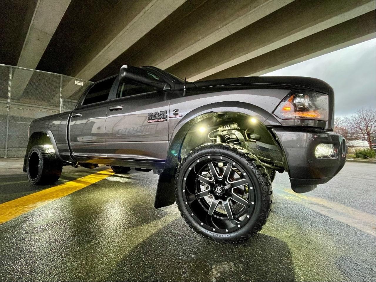 6.7L CUMMINS DIESEL, AISIN TRANS, LIFTED FOX SHOCKS, PAINTED FLARES, LIGHT BAR, ROCK LIGHTS, 22" FUEL WHEELS, 33" M/T Tires, Trigger Mud flaps, Tri Fold TONNO

RAM 3500 LARAMIE CREW CAB 4X4 
Exterior Color: Granite Crystal Metallic Interior Color: Black interior / Black seats 
Interior: Leatherfaced front vented front bucket seats 
Secondrow heated seats 
Engine: 6.7L Cummins I6 turbo diesel engine Transmission: 6speed AISIN heavyduty automatic transmission 
STANDARD EQUIPMENT (UNLESS REPLACED BY OPTIONAL EQUIPMENT)
 FUNCTIONAL / SAFETY FEATURES 
Advanced multistage front air bags 
Supplemental side curtain air bags 
Supplemental side air bags 
Supplemental front seat side air bags 
Electronic shiftonthefly transfer case 
ParkSense Front and Rear Park Assist System 
4wheel antilock disc brakes 
Antispin differential rear axle 
Electronic Stability Control 
Security alarm 
Heavyduty engine cooling 
Remote keyless entry 
Sentry Key antitheft engine immobilizer 
Locking tailgate 
Automatic headlamps 
Bifunctional halogen projector headlamps 
ParkView Rear BackUp Camera 
Class V hitch receiver 
Trailer Brake Control 
3.73 rear axle ratio 
 INTERIOR FEATURES 
Leatherfaced front 40/20/40 split bench seat 
Rear 60/40 split folding seat 
Secondrow infloor storage bins 
Power 10way memory driver & 6way passenger seats 
Power lumbar adjust 
Front heated seats 
Front ventilated seats 
Radio, driver seat and mirrors with memory settings 
Leatherwrapped steering wheel 
Steering wheelmounted audio controls 
Heated steering wheel 
A/C with dualzone automatic temperature control 
Media hub with USB port and auxiliary input jack 
Cruise control 
Power windows with front onetouch up and down 
Power locks 
Rear power sliding window 
7inch customizable incluster display 
Uconnect 8.4in Touch/SXM/Handsfree/NAVready 
8.4inch touchscreen 
9 Alpine speakers with subwoofer 
SiriusXM satellite radio with 1year subscription 
Handsfree communication with Bluetooth streaming 
 EXTERIOR FEATURES 
18x8inch polished aluminum wheels 
LT275/70R18E BSW AllSeason tires 
Monotone paint 
OPTIONAL EQUIPMENT (May Replace Standard Equipment) 
Granite Crystal Metallic $195
Leatherfaced front vented front bucket seats $1,400
Secondrow heated seats 
Customer Preferred Package 28H 
Protection Group $125
Transfer case skid plate 
Convenience Group $250
Automatic high beam headlamp control 
Rainsensing windshield wipers 
Sport Appearance Group $1,600
Black, power folding trailer tow mirrors w/ memory 20x8inch Black aluminum wheels 
LT285/60R20E OWL On/OffRoad tires 
Bifunctional projector headlamps w/ Black surround Black premium taillamps 
Bodycolour grille with Black wave insert 
Black exterior mirrors 
Painted rear bumper 
Painted front bumper 
6speed AISIN heavyduty automatic transmission $4,155
3.42 rear axle ratio 
6.7L Cummins I6 turbo diesel engine $9,345
180amp alternator 
Selective Catalytic Reduction (UREA) 
Diesel exhaust brake 
Ram Active Air 
Winter front grille cover 
Rear window defroster $225
Power sunroof $1,425
Keyless Enter n Go with pushbutton start $300
Remote proximity keyless entry 
Pickup box lighting $100
Uconnect 8.4inch Touch/SiriusXM/Handsfree/NAV $700
GPS navigation 
Singledisc remote CD player $250
Power adjustable pedals with memory 
Remote start system $395
Federal A/C Excise Tax $100
Destination Charge $1,795

Please Note this unit has a rebuilt title, Very Minor Front damage. We have all the before & after pictures and full inspection & reconditioning reports. Very Clean Truck! 

Price does not include $599 documentation fee and/or $699 finance fee.