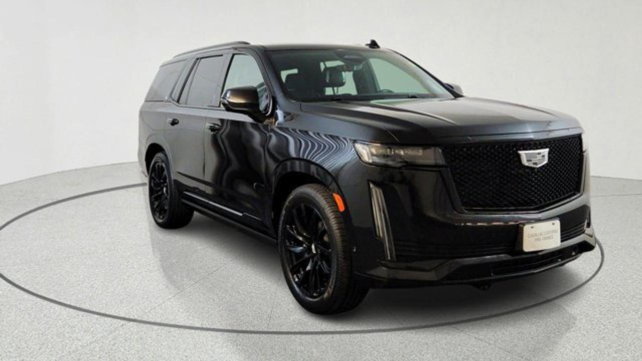The 2021 Cadillac Escalade Sport is a luxury full-size SUV that builds on the Premium Luxury trim by adding distinctive sporty exterior touches like a gloss-black mesh grille, dark-finished 22-inch alloy wheels, and black body trim that set it apart visually. It includes Premium Luxury features such as advanced driver-assistance systems, magnetic ride control, and trailering tech, while further enhancing performance with an electronic limited-slip differential. Inside, the Escalade offers a spacious, tech-rich cabin with premium materials and Cadillacs suite of convenience and comfort features that emphasize both style and capability.