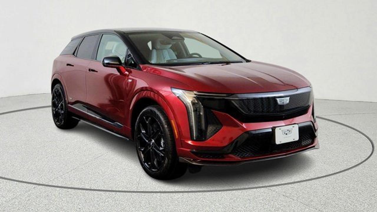 The 2026 Cadillac OPTIQ-V is an all-electric performance SUV in Cadillacs V-Series lineup, pairing a dual-motor all-wheel-drive powertrain with an estimated 519 hp and 650 lb-ft of torque. It combines sporty exterior elements like gloss-black and carbon-fiber accents with Brembo performance brakes, adaptive damping suspension, and a driver-selectable V-Mode for customizable performance settings. Inside, the luxury cabin features a large 33-inch advanced LED display, premium AKG sound with Dolby Atmos, Super Cruise hands-free driving and a suite of modern safety and driver-assist technologies. All of this is built around an EV platform with an estimated 440 km range per charge.