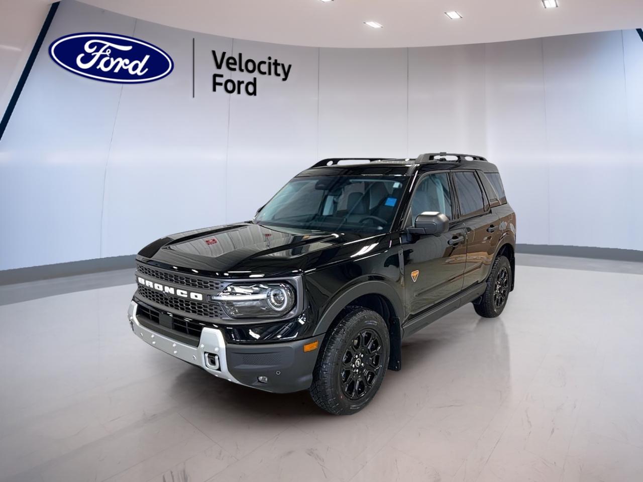 Meet the brand new 2026 Ford Bronco Sport Badlands 4x4, now at Velocity Ford in Moose Jaw. Finished in black with a dark grey interior, this 4-door SUV is built for drivers who want everyday comfort with real off-road confidence. Its 2.0 L gas engine and 8-speed automatic transmission deliver smooth power, while four-wheel drive helps you stay in control when roads turn rough.

This new 2026 Ford Bronco Sport Badlands 4x4 is ready for Saskatchewan weather and weekend plans. You get smart convenience like remote starter and push button start, plus heated mirrors and a rear window defroster for frosty mornings. Tinted windows add privacy and help keep the cabin cooler on sunny days.

FEATURES OF THE Bronco Sport Badlands 4x4  
»» 2.0 L gas engine power  
»» Four-wheel drive for confident traction  
»» Limited slip differential for better grip  
»» Off-road tires for trail-ready capability  

ADVANCED SAFETY FEATURES  
»» Anti-lock braking system for controlled stops  
»» Stability control helps maintain steady handling  
»» Blind spot monitor for safer lane changes  
»» Lane departure warning adds extra awareness  

PERFORMANCE AND EFFICIENCY  
»» 2.0 L gas engine performance  
»» 8-speed automatic for smooth shifting  
»» Dual shift mode for manual control  
»» Four-wheel drive supports all-season driving  

COMFORT AND CONVENIENCE  
»» Dual-zone automatic climate control comfort  
»» Heated front seats for cold days  
»» Power windows for easy ventilation  
»» Driver lumbar support for longer drives  

TECHNONOLGY AND CONNECTIVITY  
»» Bluetooth integration for hands-free calling  
»» WiFi hotspot helps keep you connected  
»» Satellite radio for more listening choice  
»» Steering wheel audio controls included  

CARGO SPACE  
»» Rear trunk access for easy loading  
»» Spare tire included for peace of mind  
»» Four doors ease passenger entry  
»» Practical SUV layout for daily use  

WHAT OTHER OWNERS LIKE  
»» Confident traction from four-wheel drive  
»» Helpful blind spot monitoring in traffic  
»» Remote starter for winter mornings  
»» Backup camera makes parking easier  

This 2026 Ford Bronco Sport Badlands 4x4 keeps your drive simple and secure with a backup camera, automatic headlights, fog lights, and LED headlamps for clear visibility. Inside, ambient lighting adds a modern feel, while an auto-dimming rearview mirror helps reduce glare at night. Memory mirrors and memory seats help you settle in fast, and cruise control makes highway trips more relaxed.

This 2026 Ford Bronco Sport Badlands 4x4s VIN is: 3FMCR9DA2TRE08364.