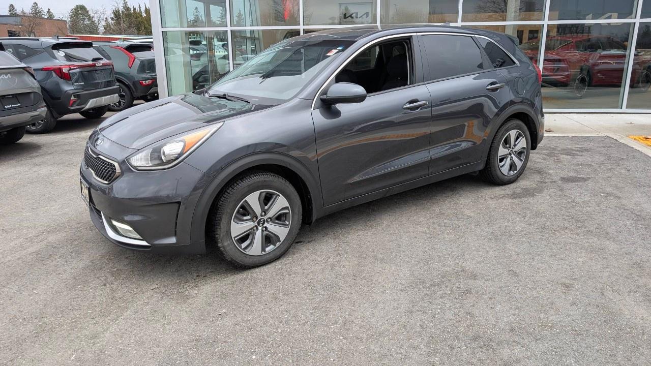 <p>Far too well equipped for the money - this is a Base model Niro Hybrid with Heated Steering wheel! Crazy!</p><p></p><p>Get into the uber hybrid efficiency for the price of a gas car. Small little CUV has lots of room for you and your gear, great styling and tech all wrapped up in a practical and super fuel efficient package.</p><p></p><p>Contact us now for your free test drive today!</p><p></p><p>Equipped with the following:</p><p></p><p>Powertrain and Mechanical:</p><p>1.6 litre GDI</p><p>6-Speed Automatic DCT</p><p>Drive Mode Select</p><p>ABS (Anti-Lock Brake System)</p><p>ISG (Idle Stop & Go)</p><p>Exterior:</p><p>16 Alloys 205/60R with Wheel Covers</p><p>Solar Glass - Windshield</p><p>Solar Glass  Front Door Windows</p><p>Privacy Glass  Rear Door and Quarter Windows</p><p>Auto Headlights (Auto light control)</p><p>Head Lamps  Halogen Projection Bi-Function</p><p>Position Lamps LED</p><p>Daytime Running Lights LED</p><p>Fog lamps</p><p>Rear Combination Lamps</p><p>High Mount Stop Lamp LED</p><p>Mud Guards</p><p>Outside Mirror  Electric Adjustable, Manual Folding, Heated</p><p>Interior/Convenience/Comfort:</p><p>Rearview Camera</p><p>Rearview Mirror  Day & Night</p><p>Tilt & Telescopic Steering (Manual)</p><p>TPMS (High Line)</p><p>Power Windows</p><p>Driver Side Front  Auto-Up/Down Windows</p><p>Passenger Side Front  Auto-Down Windows</p><p>Safety Windows  Driver Side Front</p><p>Supervision Cluster with 4.2 LCD</p><p>Sunglass Holder</p><p>Steering Wheel  Leather</p><p>Steering Wheel  Heated</p><p>Shift Knob  Leather Wrapped</p><p>FSC = G5W5K6A1TEV1DD000</p><p>Front Seat Height Adjuster  Driver (Manual 4-way)</p><p>Front Seat Height Adjuster  Passenger (Manual 4-way)</p><p>60/40 Rear Seat Folding</p><p>Cloth Seats</p><p>Luggage Net</p><p>Room Lamp Overhead Console</p><p>ACC (Auto Cruise Control)</p><p>Auto A/C  Dual Zone</p><p>Auto Defog</p><p>Scuff Plates - Standard</p><p>Keyless entry</p><p>Heated Front Driver and Passenger Seats</p><p>Audio/Connectivity:</p><p>AM/FM/MP3/Satellite Radio</p><p>Android Auto + Apple CarPlay</p><p>7 LCD Screen</p><p>AUX and USB Connection</p><p>Bluetooth</p><p>Steering Wheel Audio Controls</p><p>Safety:</p><p>TMK (Temporary Mobility Kit)</p><p>Airbags  Front Driver-Side</p><p>Airbags  Front Passenger-Side</p><p>Airbags  Front</p><p>Airbags  Curtain</p><p>Airbags  Driver-Side Knee</p><p>BAS (Brake Force Assist System)</p><p>ESC (Electronic Stability Control)</p><p>HAC (Hill Start Assist Control)</p><p>VSM (Vehicle Stability Management)</p><p></p><p>Kitchener Kias Used Car Philosophy: Provide each client with an open, honest and transparent used car buying process. With the use of real time pricing software, complimentary Carfax reports and an in-depth safety inspection review, you can rest assured that your used car purchase will offer you the best value and use of your time.</p><p>Kitchener Kia proudly serves all neighbouring communities including: Kitchener, Waterloo, Cambridge, Guelph, St. Thomas, Strathroy, Clinton, Owen Sound, Sarnia, Listowel, Woodstock, Grand Bend, Port Stanley, Belmont, Ingersoll, Brantford, Paris, and Chatham.</p>