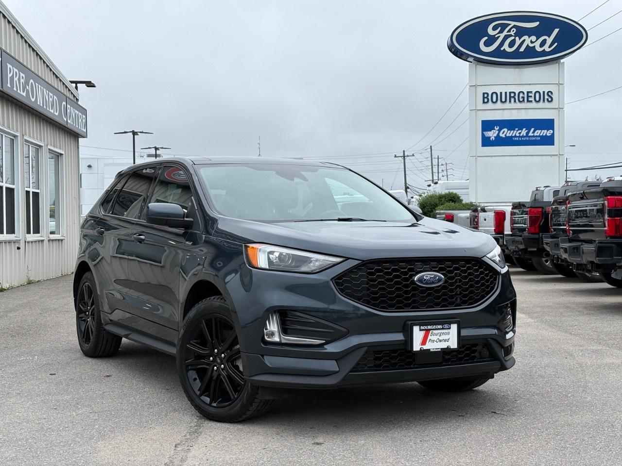 <p>The 2022 Ford Edge ST Line in vibrant blue and equipped with All-Wheel Drive offers a smooth and confident driving experience, perfect for navigating any terrain. This stylish SUV boasts an eye-catching exterior design that is complemented by modern alloy wheels and a sophisticated interior featuring a luxurious black finish.</p> <p>The interior of the Edge ST Line is designed for comfort and convenience with heated, leatherette-back material seating and a leather steering wheel. Enjoy the panoramic ride powered by the efficient 2.0L EcoBoost engine, expertly managed through an automatic transmission. For those cold Canadian winters, heated mirrors and front seats ensure a warm and clear start to your journey.</p> <p>This SUV is loaded with advanced technology and safety features that enhance every drive. Stay connected with a smart device integration system, supported by Bluetooth connectivity and a Wi-Fi hotspot. Additional features like a backup camera, brake assist, lane assist, and parking sensors provide added confidence and peace of mind, ensuring the safety of you and your loved ones.</p> <p>This SUV is an ideal choice for families or individuals seeking a vehicle that combines performance, comfort, and style. Experience the perfect companion for both urban adventures and road trips. Contact our dealership today to learn more about the Ford Edge ST Line and how you can make it yours.</p> <p><strong>Why Choose the Bourgeois Auto Group?</strong></p><p>For 80 years, Bourgeois Auto Group has been delivering exceptional automotive experiences. Our factor trained teams work to ensure you receive the shopping experience you deserve; whether you're looking for a new or new-to-you vehicle.</p><p>Shop 24/7 with our online showroom and chat service, ensuring convenience every step of the way. No hidden fees, full disclosure, and every pre-owned vehicle comes with a Carfax® report for peace of mind.</p><p>We offer a wide selection of pre-owned vehicles, all competitively priced using real-time market data. Get the best deal on your purchase and trade-in with our free Live Market Analysis report.</p><p>Looking to sell your car? We buy any make or modelno purchase required. Our simple to use online trade valuation tool will provide you with a clear, transparent selling experience whether you buy our car or not.</p><p>Backed by hundreds dedicated employees across 4 convenient locations, were here to meet all your automotive needs. Visit us in Midland or Parry Sound and explore our inventory or schedule your next service today.</p> <p><strong>Financing Your Next Vehicle with Bourgeois Motors Ford in Midland:</strong></p><p>At Bourgeois Motors Ford, we make financing your next vehicle simple and stress-free! Our team works with trusted lenders to find flexible options tailored to your budget. Drive away with confidenceapply today!</p><p>Take advantage of our online pre-qualification tool, backed by Equifax and TD Bank to find the payment that works for you. Simply <a href=https://www.bourgeoismotors.com/free-credit-check/ rel=nofollow><strong>CLICK HERE</strong></a><strong> </strong>to use our secure online credit tool with no impact to your credit.</p>