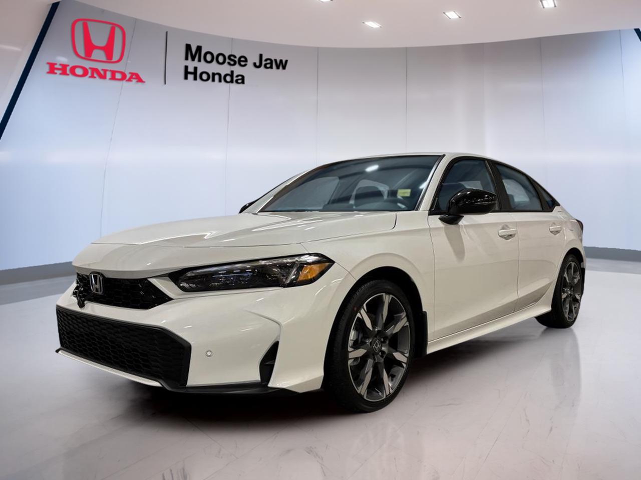 Meet the brand new 2026 Honda Civic Hybrid Sport Touring sedan, now at Moose Jaw Honda in Moose Jaw. Finished in White with a Black interior, this Civic Hybrid Sport Touring brings a clean, modern look with an easy-to-live-with layout. It is built for daily comfort, calm commuting, and confident year-round driving.

Under the hood, the 2026 Honda Civic Hybrid Sport Touring uses a 2.0 L 16-valve DOHC Dual-VTC in-line 4-cylinder engine paired with an Electro-CVT transmission. You can tailor the drive to your day with selectable ECON and Normal modes. With front-wheel drive traction, it feels natural and predictable on city streets, while staying efficient for longer highway runs.

This is a brand new sedan that fits Moose Jaw life well. It is easy to park, easy to drive, and sized for real-world needs. Whether you are headed to work, running errands, or planning a weekend trip, this Civic Hybrid Sport Touring is designed to keep things simple, smooth, and comfortable.

ADVANCED SAFETY FEATURES  
»» Designed for confident, predictable daily driving  
»» Stable front-wheel traction in varied conditions  
»» Smooth Electro-CVT response helps control  
»» Sedan visibility supports easier lane placement  

PERFORMANCE AND EFFICIENCY  
»» 2.0 L DOHC four-cylinder engine  
»» Dual-VTC design supports responsive power delivery  
»» Electro-CVT promotes smooth, steady acceleration  
»» ECON and Normal drive modes included  

COMFORT AND CONVENIENCE  
»» Practical sedan layout for everyday usability  
»» Easy-to-reach controls for quick adjustments  
»» Four-door access for simpler entry  
»» Black interior suits busy daily routines  

TECHNONOLGY AND CONNECTIVITY  
»» Clear driver information through digital interfaces  
»» Modern cabin layout supports simple operation  
»» Transmission modes selectable from the cabin  
»» Hybrid system manages power delivery smoothly  

CARGO SPACE  
»» Sedan trunk space for daily essentials  
»» Room for groceries, bags, and gear  
»» Practical shape makes loading straightforward  
»» Cabin storage supports small-item organization  

WHAT OTHER OWNERS LIKE  
»» Smooth hybrid power for commuting  
»» Easy driving feel in city traffic  
»» Comfortable ride for longer trips  
»» Simple, clean sedan visibility  

This 2026 Honda Civic Hybrid Sport Tourings VIN is: 2HGFE4F81TH007945.<p> the 2026 Honda Civic Hybrid Sport Touring uses a 2.0 L 16-valve DOHC Dual-VTC in-line 4-cylinder engine paired with an Electro-CVT transmission. You can tailor the drive to your day with selectable ECON and Normal modes. With front-wheel drive traction</p>
<p> while staying efficient for longer highway runs.

This is a brand new sedan that fits Moose Jaw life well. It is easy to park</p>
<p> predictable daily driving  
»» Stable front-wheel traction in varied conditions  
»» Smooth Electro-CVT response helps control  
»» Sedan visibility supports easier lane placement  

PERFORMANCE AND EFFICIENCY  
»» 2.0 L DOHC four-cylinder engine  
»» Dual-VTC design supports responsive power delivery  
»» Electro-CVT promotes smooth</p>
<p> steady acceleration  
»» ECON and Normal drive modes included  

COMFORT AND CONVENIENCE  
»» Practical sedan layout for everyday usability  
»» Easy-to-reach controls for quick adjustments  
»» Four-door access for simpler entry  
»» Black interior suits busy daily routines  

TECHNONOLGY AND CONNECTIVITY  
»» Clear driver information through digital interfaces  
»» Modern cabin layout supports simple operation  
»» Transmission modes selectable from the cabin  
»» Hybrid system manages power delivery smoothly  

CARGO SPACE  
»» Sedan trunk space for daily essentials  
»» Room for groceries</p>
<p> and gear  
»» Practical shape makes loading straightforward  
»» Cabin storage supports small-item organization  

WHAT OTHER OWNERS LIKE  
»» Smooth hybrid power for commuting  
»» Easy driving feel in city traffic  
»» Comfortable ride for longer trips  
»» Simple</p>