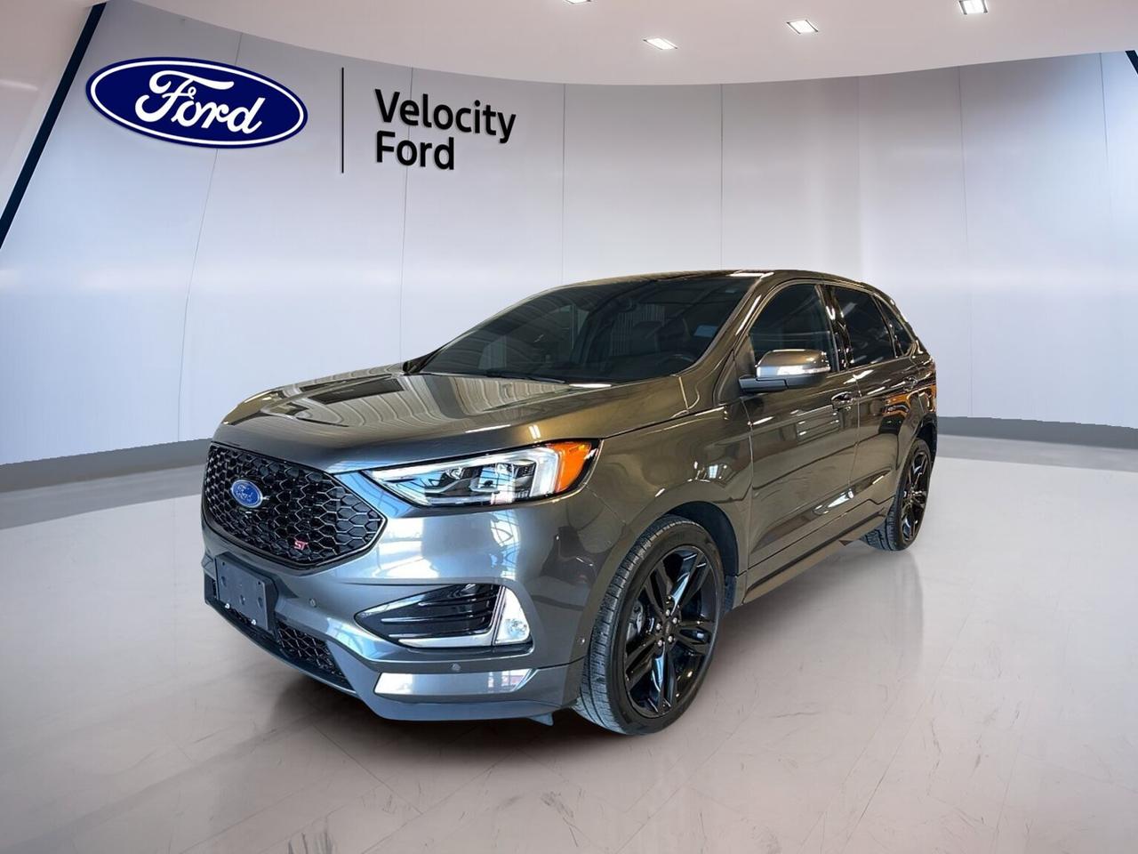 Meet the 2020 Ford Edge ST AWD, now available at Velocity Ford in Moose Jaw. Finished in sleek Grey with a Black interior, this sporty SUV blends everyday comfort with confident all-wheel-drive control. With 55,113 km, an 8-speed automatic transmission, and a 2.7 L unleaded engine, its ready for commutes, road trips, and winter streets alike.

This 2020 Ford Edge ST AWD gives you a strong, secure feel from the drivers seat. Youll also enjoy smart convenience features that make daily driving easier, like Remote Starter, Push Button Start, and a Power Liftgate. Add in a Backup Camera, Blind Spot Monitor, and Lane Departure Warning, and you have a vehicle that supports you in busy traffic and tight parking spots.

FEATURES OF THE Edge ST AWD
»» 2.7 L unleaded engine power  
»» All-wheel drive for four-season confidence  
»» 8-speed automatic with dual shift  
»» Sporty rear spoiler and fog lights  

ADVANCED SAFETY FEATURES
»» Anti-lock braking system for controlled stops  
»» Stability control helps maintain steady handling  
»» Blind spot monitor for safer lane changes  
»» Lane departure warning for added awareness  

PERFORMANCE AND EFFICIENCY
»» 2.7 L engine for strong response  
»» Automatic transmission with dual shift mode  
»» Limited slip differential for improved traction  
»» Performance tires for confident road grip  

COMFORT AND CONVENIENCE
»» Dual-zone automatic climate control comfort  
»» Heated front seats for cold mornings  
»» Memory seats for quick driver setup  
»» Power windows and power steering ease  

TECHNONOLGY AND CONNECTIVITY
»» Bluetooth integration for hands-free calling  
»» WiFi hotspot helps keep you connected  
»» Satellite radio and HD Radio included  
»» Steering wheel audio controls within reach  

CARGO SPACE
»» Power liftgate for easy loading  
»» Rear trunk access for quick packing  
»» Remote trunk release adds convenience  
»» Spare tire onboard for peace-of-mind  

WHAT OTHER OWNERS LIKE
»» Strong acceleration and confident passing power  
»» All-wheel drive stability in poor weather  
»» Comfortable cabin with supportive seating  
»» Easy-to-use tech and infotainment features  

This 2020 Ford Edge ST AWDs VIN is: 2FMPK4AP2LBA64275.