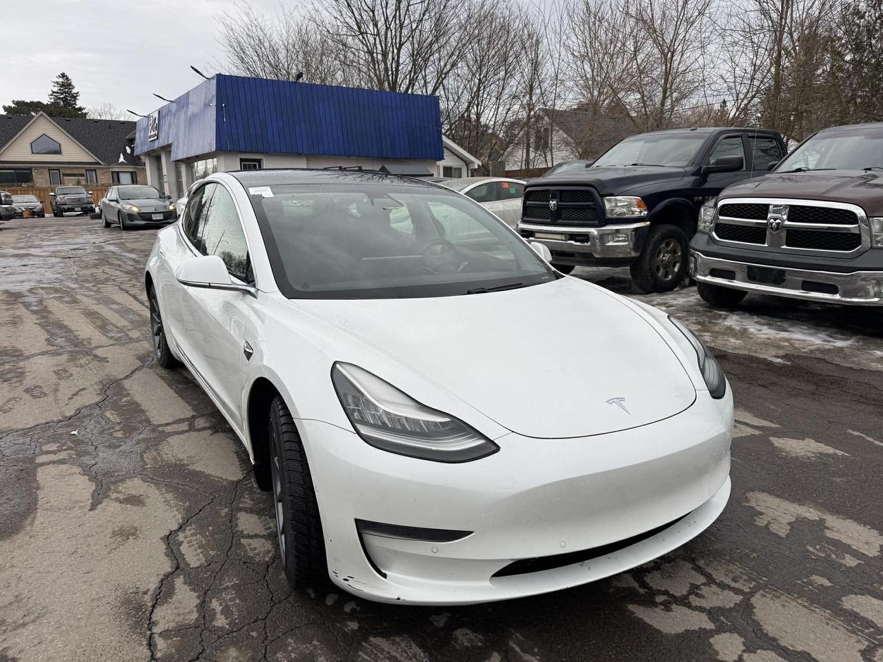 <p>Looking for an exhilarating driving experience thats also environmentally conscious? Feast your eyes on this sleek, pre-owned 2020 Tesla Model 3 Standard Range Plus RWD, now available at Mallory Auto! This all-electric sedan in a crisp white exterior and a sophisticated black interior is a true testament to modern automotive innovation. With its smooth automatic transmission and rear-wheel drive, youll experience a responsive and engaging ride thats both fun and efficient.</p><p>This Model 3 has already proven itself on Canadian roads, with 201,724 km on the odometer. Its a testament to Teslas build quality and a fantastic opportunity to own a piece of the future. The Model 3s four-door design offers practicality without compromising on style.</p><p>Here are a few features that make this 2020 Tesla Model 3 a must-see:</p><ul><li><strong>Instant Torque:</strong> Experience the heart-pounding acceleration that only an electric vehicle can deliver.</li><li><strong>Minimal Maintenance:</strong> Say goodbye to oil changes and hello to hassle-free ownership.</li><li><strong>Advanced Technology:</strong> Enjoy a cutting-edge interior, complete with a minimalist design and a large touchscreen interface.</li><li><strong>Long-Range Capability:</strong> Drive with confidence, knowing you can go the distance on a single charge.</li><li><strong>Supercharger Network Access:</strong> Enjoy the convenience of Teslas extensive Supercharger network for fast and easy charging on the go.</li></ul><p><strong><em>Powered by AutoIntelligence&trade;</em></strong> Vehicle information has been generated using artificial intelligence and is provided for informational purposes only. While efforts are made to ensure accuracy, please confirm all details directly with the dealer.</p>