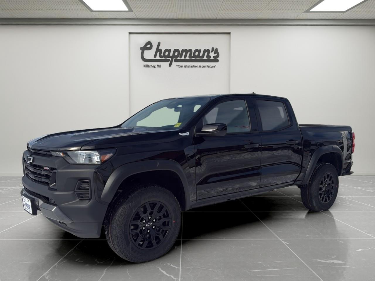 <p>Finished in Black with a Jet Black interior, this 2026 Chevrolet Colorado Trail Boss is a rugged midsize truck built for off-road capability and everyday usability. With its factory lift, aggressive stance, and Crew Cab layout, its designed for drivers who want both trail performance and practical space.</p><p>Powered by a 2.7L TurboMax engine paired with an 8-speed automatic transmission, this Colorado delivers strong torque and confident performance. Equipped with 4WD, off-road suspension, and a full trailering setup, its ready for backroads, job sites, and everything in between.</p><h3>Performance & Capability</h3><ul><li><p>2.7L TurboMax engine</p></li><li><p>8-speed automatic transmission</p></li><li><p>4WD with 2-speed Autotrac transfer case</p></li><li><p>Factory 2" lift with off-road suspension</p></li><li><p>Auto-locking rear differential</p></li><li><p>Hill descent control</p></li><li><p>Trailering package with trailer brake controller</p></li><li><p>Stabilitrak with trailer sway control</p></li><li><p>Heavy-duty 220-amp alternator</p></li></ul><h3>Interior Comfort & Convenience</h3><ul><li><p>Dual-zone automatic climate control</p></li><li><p>Remote keyless entry with push-button start</p></li><li><p>Sliding rear window</p></li><li><p>Front bucket seats with centre console</p></li><li><p>6-way driver seat adjuster</p></li><li><p>Rear 60/40 split folding bench with storage</p></li><li><p>Rear window defogger</p></li><li><p>Carpeted floor mats</p></li></ul><h3>Technology & Connectivity</h3><ul><li><p>11.3" touchscreen with Google built-in</p></li><li><p>Wireless Apple CarPlay & Android Auto</p></li><li><p>11" digital driver information centre</p></li><li><p>SiriusXM satellite radio</p></li><li><p>OnStar services with Wi-Fi capability</p></li><li><p>USB connectivity</p></li></ul><h3>Safety & Driver Assistance</h3><ul><li><p>Automatic emergency braking</p></li><li><p>Forward collision alert</p></li><li><p>Front pedestrian & bicyclist braking</p></li><li><p>Lane keep assist with departure warning</p></li><li><p>Blind zone steering assist with trailering</p></li><li><p>Rear cross traffic braking</p></li><li><p>Following distance indicator</p></li><li><p>IntelliBeam automatic high beams</p></li></ul><h3>Exterior Highlights</h3><ul><li><p>18" high gloss black aluminum wheels</p></li><li><p>265/65R18 all-terrain tires</p></li><li><p>Factory lift and wider stance</p></li><li><p>Spray-on bedliner</p></li><li><p>StowFlex tailgate</p></li><li><p>CornerStep rear bumper</p></li><li><p>Front recovery hooks</p></li><li><p>Deep-tinted rear glass</p></li><li><p>Black exterior accents and nameplates</p></li></ul><p>A lifted, off-road-ready midsize truck that delivers strong turbocharged performance, modern tech, and everyday versatility.</p><p>2 Year/24,000 kilometer* Complimentary Oil Changes (2 total)</p><p>3 Year/60,000 kilometer* Base Warranty Coverage</p><p>5 Year/100,000 kilometer* Powertrain Component Warranty Coverage</p><p>5 Year/100,000 kilometer* Courtesy Transportation and 24/7 Roadside Assistance</p><p>6 Year/160,000 kilometer* Sheet Metal (Rust Through) Perforation Warranty Coverage</p><p>*Whichever Comes First.</p><p>Price Includes Dealer Fee.</p><p>Price Excludes PST & GST.</p><p>Financing Options Available, Call For More Details.</p> <p><strong>*While every reasonable effort is made to ensure the accuracy of this information, we are not responsible for any error or omissions contained on these pages. Please verify any information in question with Chapman Motors Ltd.</strong></p>
