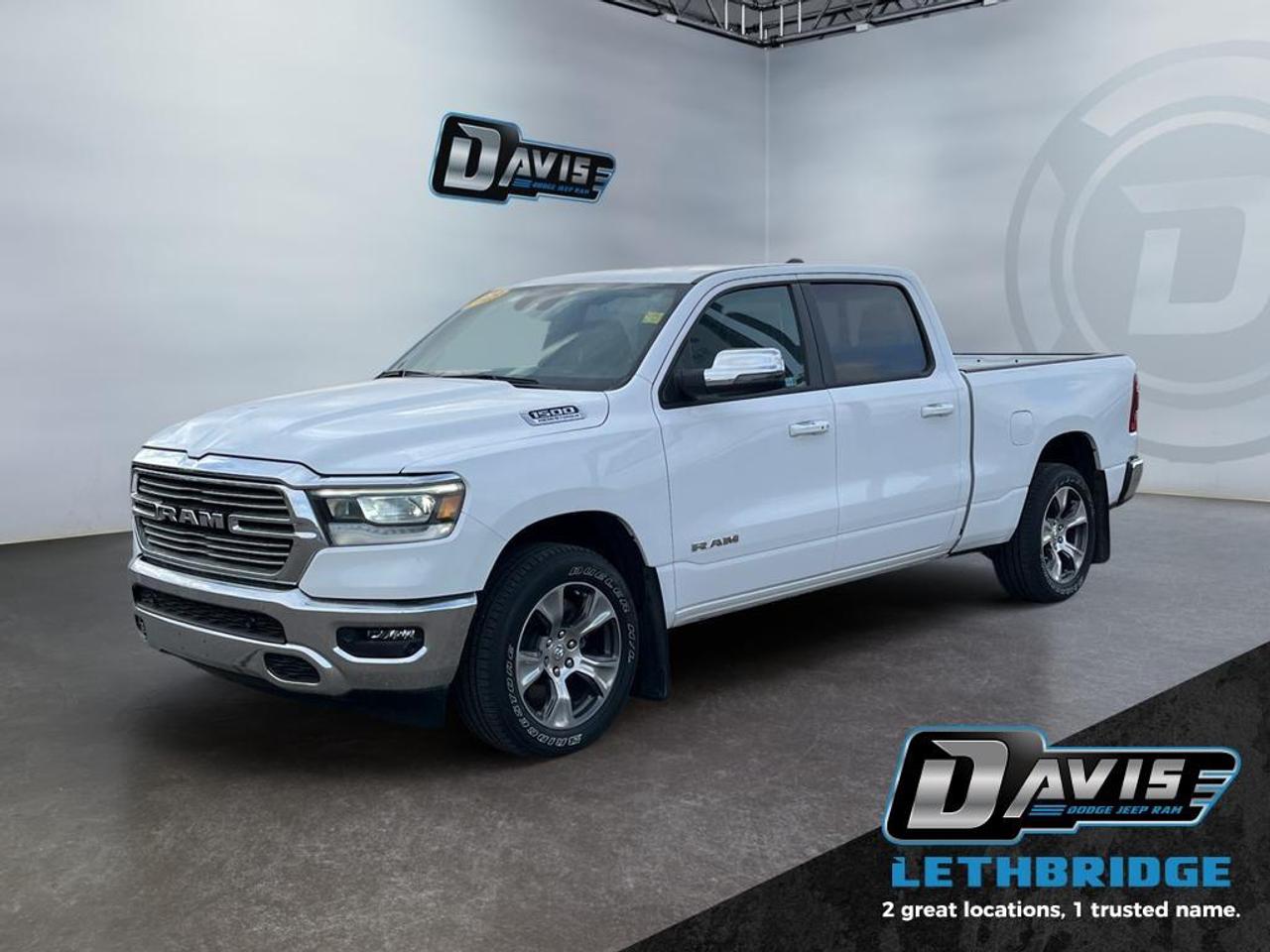 <b>Low Mileage, Navigation, Remote Start, 4G Wi-Fi, Heated Steering Wheel!<br /> <br /></b><br /> The 2023 Ram 1500 Laramie 4x4 Crew Cab delivers a perfect blend of power, luxury, and capability, making it an ideal full-size truck for both work and everyday driving. Equipped with a proven 5.7L HEMI V8 engine with eTorque and an 8-speed automatic transmission, this Ram provides strong towing performance and smooth acceleration. With its electronic shift-on-demand 4WD system, 3.92 rear axle ratio, and engine block heater, its built to handle tough Canadian conditions with confidence year-round.<br /><br />Inside, the Laramie trim offers a refined cabin loaded with premium features designed for comfort and convenience. Leather-trimmed seating, heated and ventilated front seats, a heated steering wheel, and power-adjustable seats with memory ensure a first-class driving experience. The Laramie Level 1 Equipment Group enhances functionality with remote start, rain-sensing windshield wipers, and a power sliding rear window, while the spacious Crew Cab and 6-foot box provide excellent versatility for passengers and cargo alike.<br /><br />Technology and safety are at the forefront with a large 12-inch touchscreen featuring the Uconnect 5 NAV system, offering Apple CarPlay, Android Auto, built-in navigation, SiriusXM 360L, and a 4G LTE Wi-Fi hotspot. A premium 9-speaker audio system with subwoofer delivers impressive sound quality, while advanced safety features such as Blind Spot Monitoring, ParkSense front and rear park assist with stop, Forward Collision Warning with Active Braking, and a ParkView rear backup camera provide added peace of mind. Finished in Bright White with 20-inch aluminum wheels and chrome accents, this Ram 1500 Laramie stands out with both style and capability.<br /> <br />To apply right now for financing use this link: <a href=https://lethbridge.davisdodge.ca/free-credit-check/ target=_blank rel=nofollow noopener noreferrer>https://lethbridge.davisdodge.ca/free-credit-check/</a><br /><br /> <br /><br />Locally Owned & Trusted for Over 35 Years  Davis Dodge in Lethbridge, AB <br /><br /> At Davis Dodge, weve proudly served the Lethbridge community for more than 35 years, offering an unparalleled car buying experience. Dont just take our word for itour Google reviews speak volumes about our commitment to exceptional service. <br /><br /> Delivery & At-Home Test Drives: Convenient options to suit your lifestyle. <br /><br /> Flexible Financing for Everyone: Get the vehicle you need with financing solutions tailored to your situation. <br /><br /> Full Mechanical Inspections & Professional Cleaning: Every vehicle is thoroughly inspected and cleaned before it hits our lot.<br /><br /> We take all makes and models on trade and offer competitive pricing with inventory that changes daily. Whether you're shopping for a Chrysler, Dodge, Jeep, RAM, or FIAT, our AMVIC Licensed dealership makes it easy to browse, buy, and drive away.<br /><br /> Located in Lethbridge, AB, we proudly serve customers in Fort Macleod, Taber, Claresholm, and Coaldale. Shop online or visit us today to experience the best in sales, service, and selection. Standard bank rates apply; taxes are additional.<br /><br /> Vehicle pricing offer shown expires 2026-04-30. <br /> Come by and check out our fleet of 70+ used cars and trucks and 110+ new cars and trucks for sale in Lethbridge. o~o