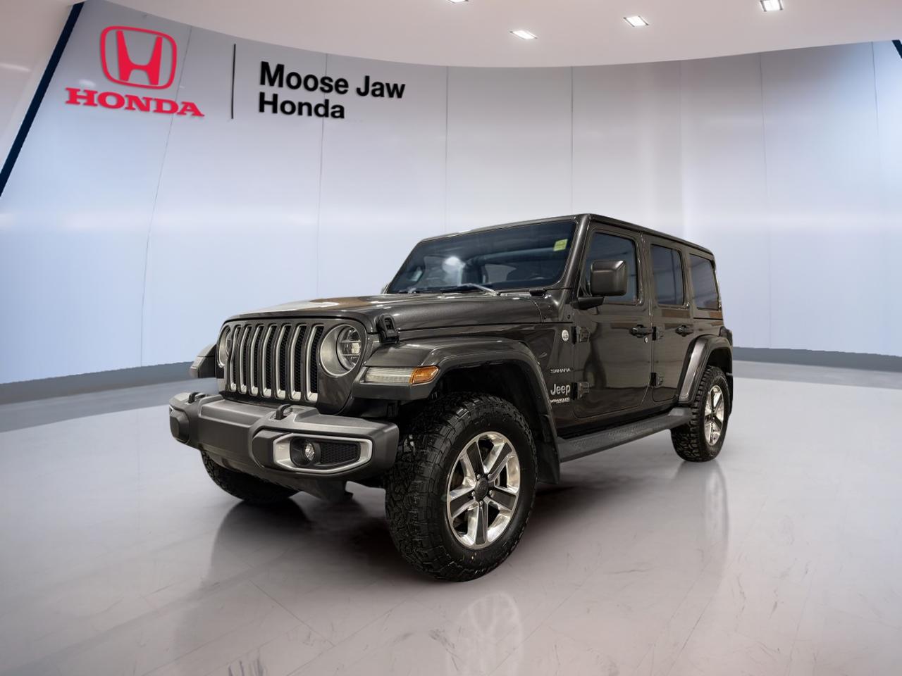 The 2020 Jeep Wrangler Sahara is built for drivers who want real Jeep capability with everyday ease. This used example at Moose Jaw Honda comes finished in Grey, paired with an automatic transmission, and shows 91,000 km. It delivers the classic Wrangler experience with removable roof and door possibilities, strong road presence, and the open-air freedom that has made this Jeep a favourite across Canada.

This 2020 Jeep Wrangler Sahara blends rugged design with comfort-focused driving manners. Its four-door layout adds daily practicality, while the upright body style helps visibility in town and on the highway. For shoppers in Moose Jaw looking for a versatile SUV with proven off-road roots and year-round confidence, this Wrangler Sahara stands out as a smart used choice.

FEATURES OF THE Wrangler Sahara
»» Iconic Jeep styling with refined details
»» Four-door utility for daily flexibility
»» Commanding ride height aids visibility
»» Open-air design adds unique freedom

ADVANCED SAFETY FEATURES
»» Electronic stability control helps maintain direction
»» Four-wheel anti-lock disc braking system included
»» Advanced multistage front airbags for protection
»» Tire pressure monitoring supports safer driving

PERFORMANCE AND EFFICIENCY
»» Automatic transmission delivers smooth daily driving
»» Four-wheel drive supports changing road conditions
»» Strong Jeep capability for varied terrain
»» Solid balance of power and control

COMFORT AND CONVENIENCE
»» Four-door cabin improves passenger access
»» Spacious interior supports everyday usability
»» Elevated seating position boosts driver confidence
»» Practical layout suits city and highway

TECHNONOLGY AND CONNECTIVITY
»» Easy-to-read driver information display included
»» Well-placed controls support simple operation
»» Modern cabin design feels user-friendly
»» Convenient interface keeps functions within reach

CARGO SPACE
»» Rear cargo area handles daily gear
»» Flexible storage supports weekend travel needs
»» Wide opening helps loading larger items
»» Cabin offers useful small-item storage

AWARDS & RECOGNITIONS
»» Best Resale Value Award, Canadian Black Book, 2020
»» Lowest Cost to Own, Kelley Blue Book, 2020

WHAT OTHER OWNERS LIKE
»» Open-air driving creates a fun experience
»» Strong off-road ability inspires confidence
»» Upright design gives excellent outward visibility
»» Four-door practicality suits active lifestyles

The 2020 Jeep Wrangler Sahara remains one of the most recognizable utility vehicles on the road. Its design is purposeful, with short overhangs, a tall stance, and the kind of durability buyers expect from Jeep. The Grey exterior gives it a clean, modern look that works well in every season and keeps the appearance understated yet rugged.

Inside, this 2020 Jeep Wrangler Sahara offers a practical cabin made for real use. The layout is simple to understand, and the driving position gives a clear view ahead. The automatic transmission also makes this Wrangler easier to enjoy in traffic, around town, and on longer highway trips through Saskatchewan.

For many buyers, the appeal of the 2020 Jeep Wrangler Sahara is how well it handles both work and play. It can serve as a daily driver during the week, then head out for a weekend escape with confidence. Its useful cargo area, flexible cabin, and proven Jeep character help it fit many lifestyles.

At Moose Jaw Honda, this used 2020 Jeep Wrangler Sahara is a compelling option for drivers who want authentic Jeep heritage with practical four-door usability. With 91,000 km, automatic transmission, and a Grey exterior, it offers the kind of value, capability, and personality that few SUVs can match.

This 2020 Jeep Wrangler Saharas VIN is: 1C4HJXEN5LW177318.<p>The 2020 Jeep Wrangler Sahara is built for drivers who want real Jeep capability with everyday ease. This used example at Moose Jaw Honda comes finished in Grey</p>
<p> and the open-air freedom that has made this Jeep a favourite across Canada.

This 2020 Jeep Wrangler Sahara blends rugged design with comfort-focused driving manners. Its four-door layout adds daily practicality</p>
<p> while the upright body style helps visibility in town and on the highway. For shoppers in Moose Jaw looking for a versatile SUV with proven off-road roots and year-round confidence</p>
<p> this Wrangler Sahara stands out as a smart used choice.

FEATURES OF THE Wrangler Sahara
»» Iconic Jeep styling with refined details
»» Four-door utility for daily flexibility
»» Commanding ride height aids visibility
»» Open-air design adds unique freedom

ADVANCED SAFETY FEATURES
»» Electronic stability control helps maintain direction
»» Four-wheel anti-lock disc braking system included
»» Advanced multistage front airbags for protection
»» Tire pressure monitoring supports safer driving

PERFORMANCE AND EFFICIENCY
»» Automatic transmission delivers smooth daily driving
»» Four-wheel drive supports changing road conditions
»» Strong Jeep capability for varied terrain
»» Solid balance of power and control

COMFORT AND CONVENIENCE
»» Four-door cabin improves passenger access
»» Spacious interior supports everyday usability
»» Elevated seating position boosts driver confidence
»» Practical layout suits city and highway

TECHNONOLGY AND CONNECTIVITY
»» Easy-to-read driver information display included
»» Well-placed controls support simple operation
»» Modern cabin design feels user-friendly
»» Convenient interface keeps functions within reach

CARGO SPACE
»» Rear cargo area handles daily gear
»» Flexible storage supports weekend travel needs
»» Wide opening helps loading larger items
»» Cabin offers useful small-item storage

AWARDS & RECOGNITIONS
»» Best Resale Value Award</p>
<p> 2020

WHAT OTHER OWNERS LIKE
»» Open-air driving creates a fun experience
»» Strong off-road ability inspires confidence
»» Upright design gives excellent outward visibility
»» Four-door practicality suits active lifestyles

The 2020 Jeep Wrangler Sahara remains one of the most recognizable utility vehicles on the road. Its design is purposeful</p>
<p> modern look that works well in every season and keeps the appearance understated yet rugged.

Inside</p>
<p> this 2020 Jeep Wrangler Sahara offers a practical cabin made for real use. The layout is simple to understand</p>
<p> and the driving position gives a clear view ahead. The automatic transmission also makes this Wrangler easier to enjoy in traffic</p>
<p> the appeal of the 2020 Jeep Wrangler Sahara is how well it handles both work and play. It can serve as a daily driver during the week</p>
<p> this used 2020 Jeep Wrangler Sahara is a compelling option for drivers who want authentic Jeep heritage with practical four-door usability. With 91</p>
<p> and personality that few SUVs can match.

This 2020 Jeep Wrangler Saharas VIN is: 1C4HJXEN5LW177318.</p>