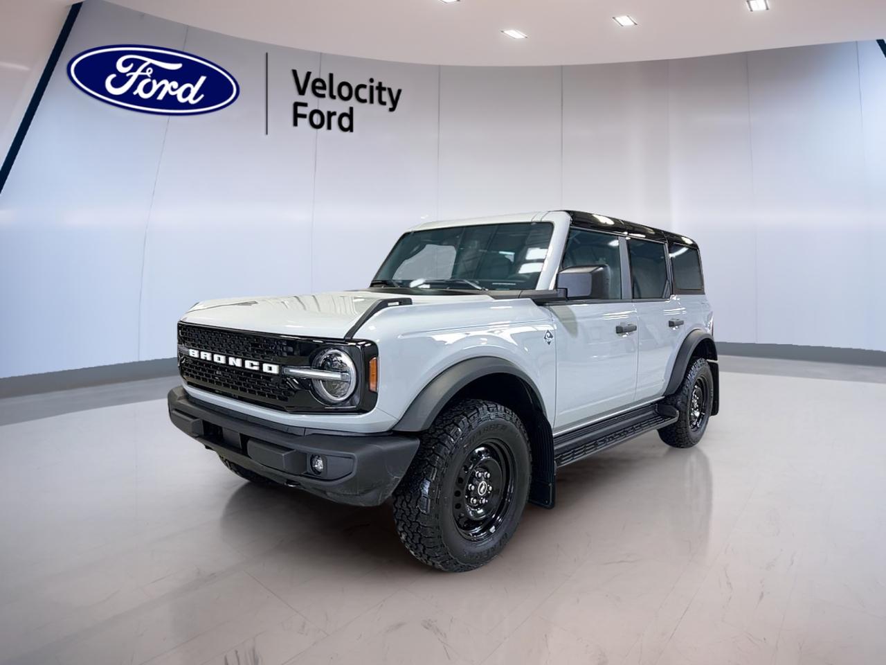 Built for open-air freedom and everyday ease, this brand new 2026 Ford Bronco Outer Banks at Velocity Ford in Moose Jaw brings classic Bronco spirit with modern power. Its White exterior and Black interior give it a clean, confident look, while four doors add easy access for passengers and gear.

This 2026 Ford Bronco Outer Banks is powered by a 2.7-litre EcoBoost V6 engine paired with a 10-speed automatic transmission. That setup delivers smooth response and strong low-end pull for highway merging, city driving, and weekend escapes. An engine block heater also helps support easier cold-weather starts in Saskatchewan.

FEATURES OF THE Bronco Outer Banks
»» Four-door body adds daily driving practicality
»» White exterior with Black interior
»» 2.7-litre EcoBoost V6 engine power
»» Engine block heater for cold starts

ADVANCED SAFETY FEATURES
»» Four-wheel disc brakes support controlled stopping
»» AdvanceTrac helps maintain directional stability
»» Tire pressure monitoring aids awareness
»» Lower anchors help secure child seats

PERFORMANCE AND EFFICIENCY
»» 2.7-litre EcoBoost V6 delivers strong output
»» 10-speed automatic supports smooth shifting
»» Turbocharged power helps confident passing response
»» Unleaded fuel operation keeps refuelling simple

COMFORT AND CONVENIENCE
»» Four doors improve passenger access
»» Spacious cabin supports daily versatility
»» Engine block heater aids winter mornings
»» Practical layout keeps controls close

TECHNONOLGY AND CONNECTIVITY
»» Driver information display supports quick checks
»» Automatic transmission manages shifts smoothly
»» Clear gauge layout aids visibility
»» Modern cabin design feels user-friendly

CARGO SPACE
»» Four-door design helps loading convenience
»» Rear cargo area supports travel gear
»» Flexible space suits daily errands
»» Roomy interior helps carry essentials

WHAT OTHER OWNERS LIKE
»» Strong turbocharged V6 acceleration feel
»» Easy access from four-door layout
»» Confident road presence and visibility
»» Useful balance of comfort and utility

The 2026 Ford Bronco Outer Banks is made for drivers who want real versatility without giving up style or power. Its upright stance, practical cabin, and responsive turbocharged engine create a vehicle that feels ready for changing weather, busy weekdays, and spontaneous road trips across Saskatchewan.

This Bronco keeps things focused on what matters most. The four-door layout makes entry and exit simple, especially for families, friends, or anyone loading up for the day. The White exterior has a fresh, crisp finish, and the Black interior adds a clean, durable feel that suits both work and recreation.

Under the hood, the 2.7-litre EcoBoost V6 gives this 2026 Ford Bronco Outer Banks the kind of output drivers appreciate when roads open up. The 10-speed automatic helps make that power easy to use, giving smooth changes through the gears and a composed feel in many driving conditions.

For Moose Jaw winters, the included engine block heater is a welcome feature. It helps prepare the engine in cold temperatures, making early starts easier and adding daily convenience when the forecast turns harsh. That is a smart addition for local driving and year-round confidence.

If you want a brand new SUV with proven Ford capability, bold Bronco identity, and the right features for Canadian weather, this 2026 Ford Bronco Outer Banks deserves a close look. Visit Velocity Ford in Moose Jaw and see how this new Bronco fits your next drive.

This 2026 Ford Bronco Outer Bankss VIN is: 1FMEE8BP1TLA47309.