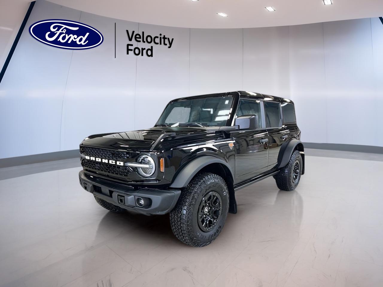 Built for serious adventure and everyday use, this brand new 2026 Ford Bronco Badlands 4 Door With Sasquatch Pkg & Black appearance Pkg delivers classic open-air freedom with modern off-road confidence. Finished in Black with a Black interior, it brings bold style, four-door practicality, and a rare 7-speed manual transmission for drivers who want full control.

In Moose Jaw, this new SUV stands out with real trail-ready equipment and useful comfort features. The 2026 Ford Bronco Badlands 4 Door With Sasquatch Pkg & Black appearance Pkg pairs a 2.7-litre unleaded engine with four-wheel drive, off-road tires, a limited slip differential, and rear tow hook capability for confident travel on rough ground.

FEATURES OF THE Bronco Badlands 4 Door With Sasquatch Pkg & Black appearance Pkg

»» Four-door body adds daily driving versatility
»» Black appearance package adds dark styling
»» Sasquatch package boosts off-road capability
»» Convertible design brings open-air freedom

ADVANCED SAFETY FEATURES

»» Backup camera helps with reversing visibility
»» Blind spot monitor supports safer lane changes
»» Lane departure warning adds extra awareness
»» Side and head airbags enhance protection

PERFORMANCE AND EFFICIENCY

»» 2.7-litre unleaded engine delivers strong power
»» Seven-speed manual transmission adds driver control
»» Four-wheel drive supports rough terrain traction
»» Limited slip differential improves off-road grip

COMFORT AND CONVENIENCE

»» Heated front seats add cold-weather comfort
»» Dual-zone climate control helps cabin comfort
»» Cruise control supports relaxed highway driving
»» Power windows add everyday ease

TECHNONOLGY AND CONNECTIVITY

»» Navigation system helps guide every trip
»» Bluetooth integration supports hands-free communication
»» WiFi hotspot keeps devices connected
»» Steering wheel audio controls aid convenience

CARGO SPACE

»» Rear trunk access simplifies daily loading
»» Four-door layout improves passenger entry ease
»» Spare tire adds travel reassurance
»» Flexible SUV space suits gear well

WHAT OTHER OWNERS LIKE

»» Strong off-road ability inspires driver confidence
»» Open-air convertible design adds more fun
»» Manual gearbox gives engaging control feel
»» Heated seats improve cold-day comfort

This Bronco is equipped with practical features that make daily driving easier. Heated mirrors, electric mirrors, automatic headlights, fog lights, tinted windows, push button start, automatic door locks, and power steering all help this SUV feel ready for both city streets and remote trails.

Inside, the layout supports comfort and function without overdoing it. Front air conditioning, automatic climate control, an adjustable steering wheel, illuminated vanity mirrors, ambient lighting, satellite radio, and a leather-wrapped steering wheel help create a cabin that feels useful, comfortable, and easy to enjoy every day.

Safety and control remain a key part of this new SUV. Anti-lock braking, stability control, tire pressure monitoring, child safety locks, driver and passenger airbags, passenger airbag sensor coverage, and LED headlamps help support peace of mind when road and weather conditions change.

For drivers in Moose Jaw who want a capable new SUV with true off-road hardware, open-top fun, and the rare feel of a manual transmission, this Bronco is an exciting choice. It offers the utility of four doors, the confidence of 4WD, and the rugged character that has made Bronco a favourite with adventure-minded drivers.

This 2026 Ford Bronco Badlands 4 Door With Sasquatch Pkg & Black appearance Pkgs VIN is: 1FMEE9BP2TLA47602.