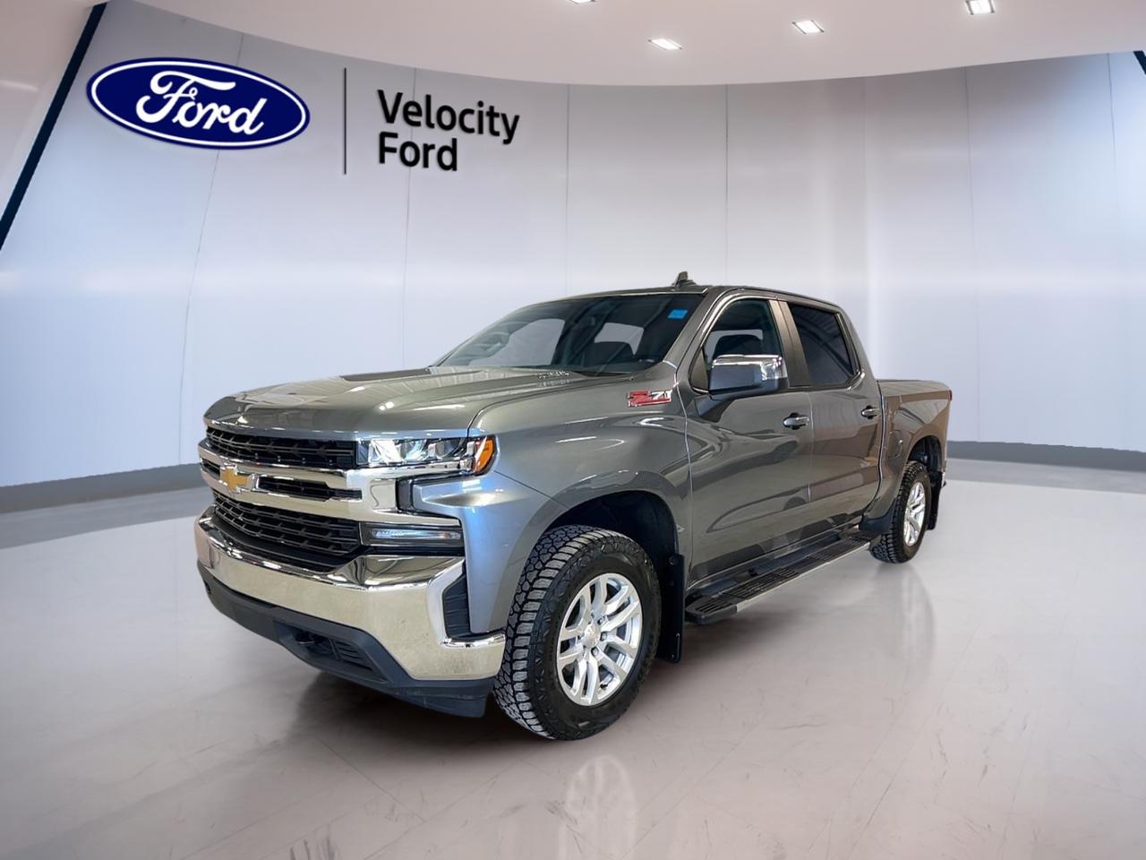 The 2021 Chevrolet Silverado 1500 Crew Cab Short Box 4-Wheel Drive LT 3.0 DURAM is a full-size diesel truck built for hard work and daily comfort. Offered by Velocity Ford in Moose Jaw, this used Silverado shows 125,262 km and pairs a Gold exterior with a Grey interior for a clean, practical look.

With four full doors, an 8-speed automatic transmission, and a 3.0-litre diesel engine, this 2021 Chevrolet Silverado 1500 Crew Cab Short Box 4-Wheel Drive LT 3.0 DURAM delivers smooth power and strong pulling ability. Its 4WD system and 5,034 kg towing capacity make it a solid fit for hauling, travel, and year-round Prairie driving.

FEATURES OF THE Silverado 1500 Crew Cab Short Box 4-Wheel Drive LT 3.0 DURAM

»» 3.0-litre diesel engine with strong torque
»» Crew Cab adds roomy rear seating
»» Short Box supports daily utility
»» 8-speed automatic for smooth shifting

TRUCK FEATURES

»» Tows up to 5,034 kg confidently
»» Four-wheel drive adds all-season traction
»» Rear tow hook supports jobsite utility
»» Limited slip differential aids tough surfaces

ADVANCED SAFETY FEATURES

»» Backup camera helps while reversing
»» Anti-lock braking system aids control
»» Stability control supports secure handling
»» Side and head airbags included

PERFORMANCE AND EFFICIENCY

»» 3.0-litre diesel engine delivers efficiency
»» Automatic 8-speed transmission shifts smoothly
»» Four-wheel drive boosts road confidence
»» Power steering supports easy manoeuvres

COMFORT AND CONVENIENCE

»» Heated front seats add cold-weather comfort
»» Dual-zone climate control helps everyone
»» Rear air conditioning aids passenger comfort
»» Remote starter adds daily convenience

TECHNONOLGY AND CONNECTIVITY

»» Bluetooth integration supports hands-free calling
»» WiFi hotspot keeps devices connected
»» Satellite radio expands entertainment choices
»» Steering wheel audio controls simplify use

CARGO SPACE

»» Short Box handles gear and supplies
»» Rear trunk access improves loading ease
»» Crew Cab offers cabin storage room
»» Four-door layout helps passenger access

AWARDS & RECOGNITIONS

»» Best Buy Award, Consumer Guide Automotive, 2021

WHAT OTHER OWNERS LIKE

»» Strong diesel torque for towing confidence
»» Comfortable ride for daily driving
»» Spacious Crew Cab for passengers
»» Useful tech features for connectivity

This Silverado is equipped with power windows, heated and electric mirrors, cruise control, push button start, front air conditioning, automatic climate control, rear climate control, rear window defroster, tinted windows, tire pressure monitoring, and a drivers power seat with lumbar support. These features help make each drive more comfortable and easier to manage.

The cabin is designed for practical use, with simple controls and smart everyday function. A leather-wrapped steering wheel, adjustable steering wheel, power outlet, automatic door locks, passenger airbag sensor, and strong climate features all support comfort for both workdays and long highway trips in this 2021 Chevrolet Silverado 1500 Crew Cab Short Box 4-Wheel Drive LT 3.0 DURAM.

For drivers who need diesel efficiency, real towing strength, and a roomy four-door cabin, this truck stands out as a dependable choice. The Gold finish gives it a distinct look, while the proven diesel powertrain and useful equipment help this 2021 Chevrolet Silverado 1500 Crew Cab Short Box 4-Wheel Drive LT 3.0 DURAM meet the needs of busy Canadian drivers.

This 2021 Chevrolet Silverado 1500 Crew Cab Short Box 4-Wheel Drive LT 3.0 DURAMs VIN is: 3GCUYDET6MG451990.